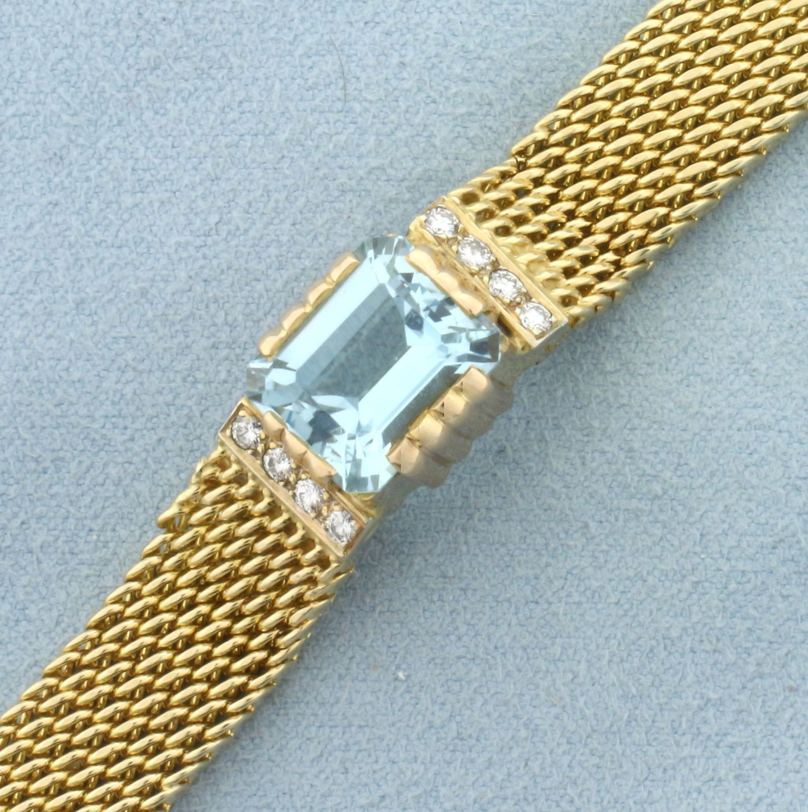 Vintage Aquamarine and Diamond Statement Bracelet in 14k Yellow and Rose Gold: In 14k yellow gold with rose gold accents. Contains one high quality natural emerald cut 5.5ct Aquamarine gemstone with beautiful color and excellent clarity. Also contains 8 high quality round