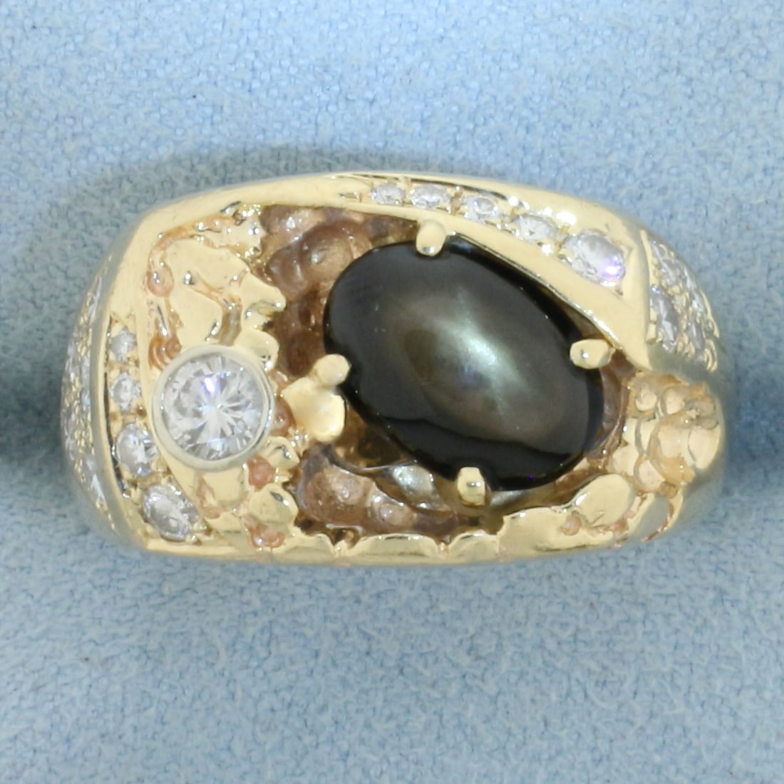 Mens Black Star Sapphire and Diamond Ring in 14k Yellow Gold: In 14k Yellow Gold. Contains one 10x7mm high quality natural Black Star Sapphire gemstone with distinctive "star" under light. Also contains twenty one high quality diamonds ranging from .01ct to