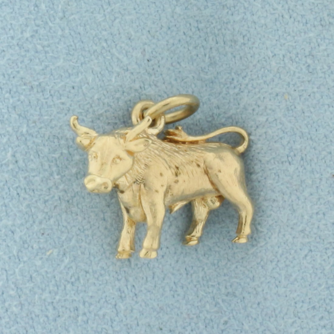 Vintage Bull Charm in 9k Yellow Gold: In 9k Yellow Gold. 5/8 inch long (including jump ring). 5/8 inch wide. European made. 3.1g.
