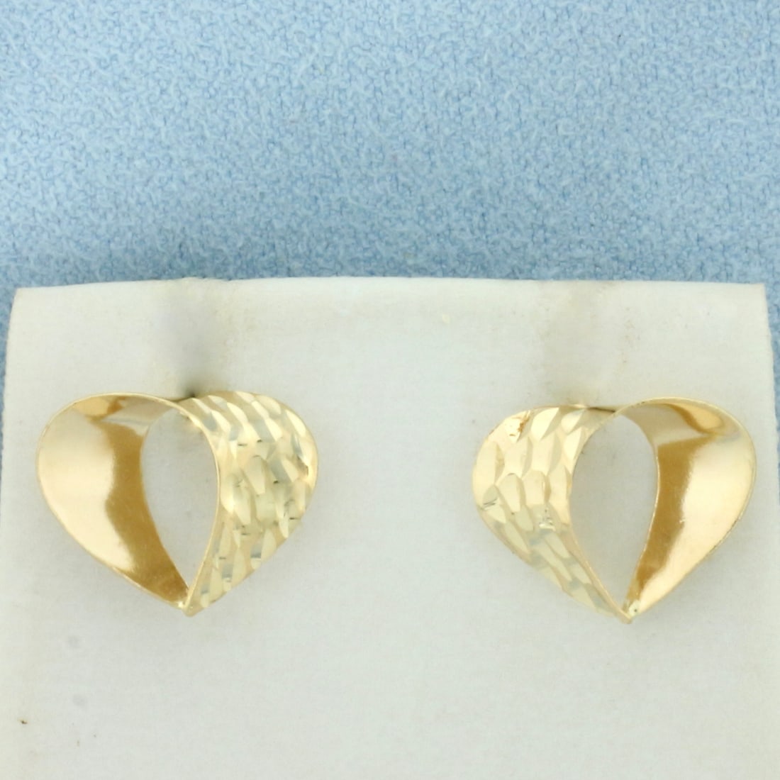 Diamond Cut Open Heart Earrings in 14k Yellow Gold: In 14k Yellow Gold. 1/2 inch diameter. Friction backs. 0.9g.