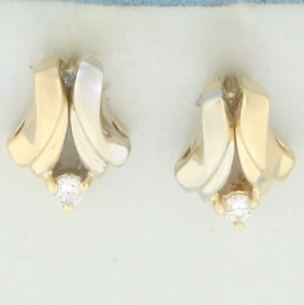 Diamond Two-Tone Earrings in 14k Yellow and White Gold: In 14k Yellow and White Gold. Contains two high quality .05ct diamonds, VS clarity/H color. 1/2 inch long. 3/8 inch wide. Friction backs. 2.4g.