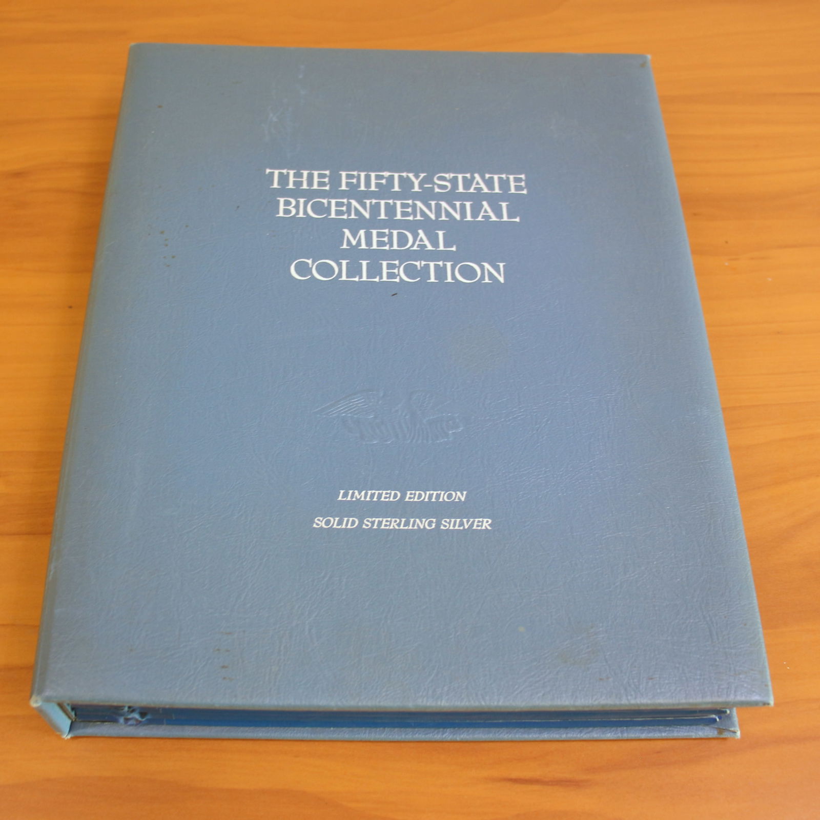 Franklin Mint Complete Fifty-State Bicentennial Medal Collection: Contains fifty State Bicentennial Solid Sterling Silver Medals. Includes original metal holder/book.