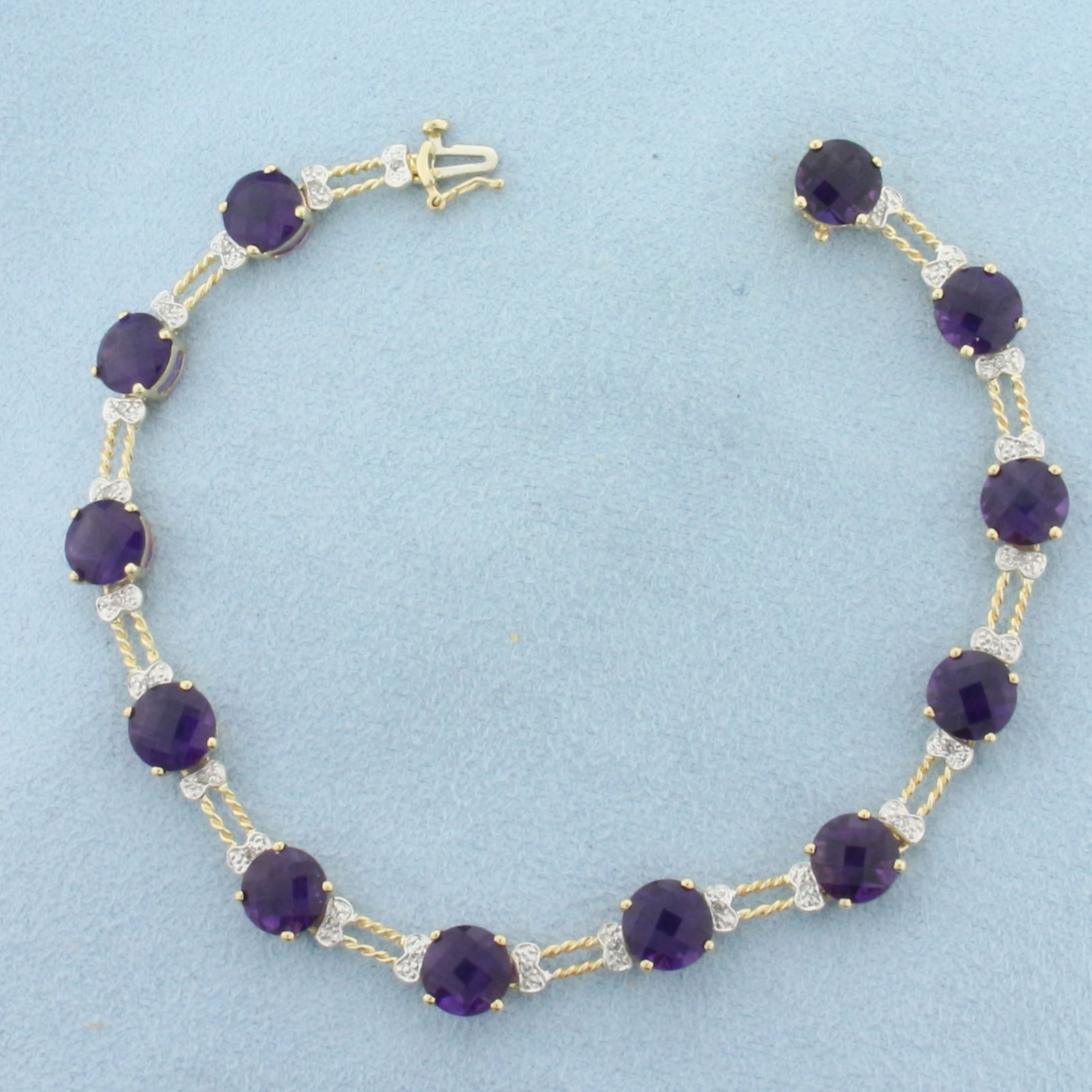 Checkerboard Cut Amethyst and Diamond Tennis Bracelet in 10K Yellow Gold: In 10k yellow gold. Measures 7.5 inches long. Contains 12 high quality natural 7mm fancy checkerboard cut Amethyst Gemstones, approximately 14ct TW, with vibrant color and excellent clarity. Also