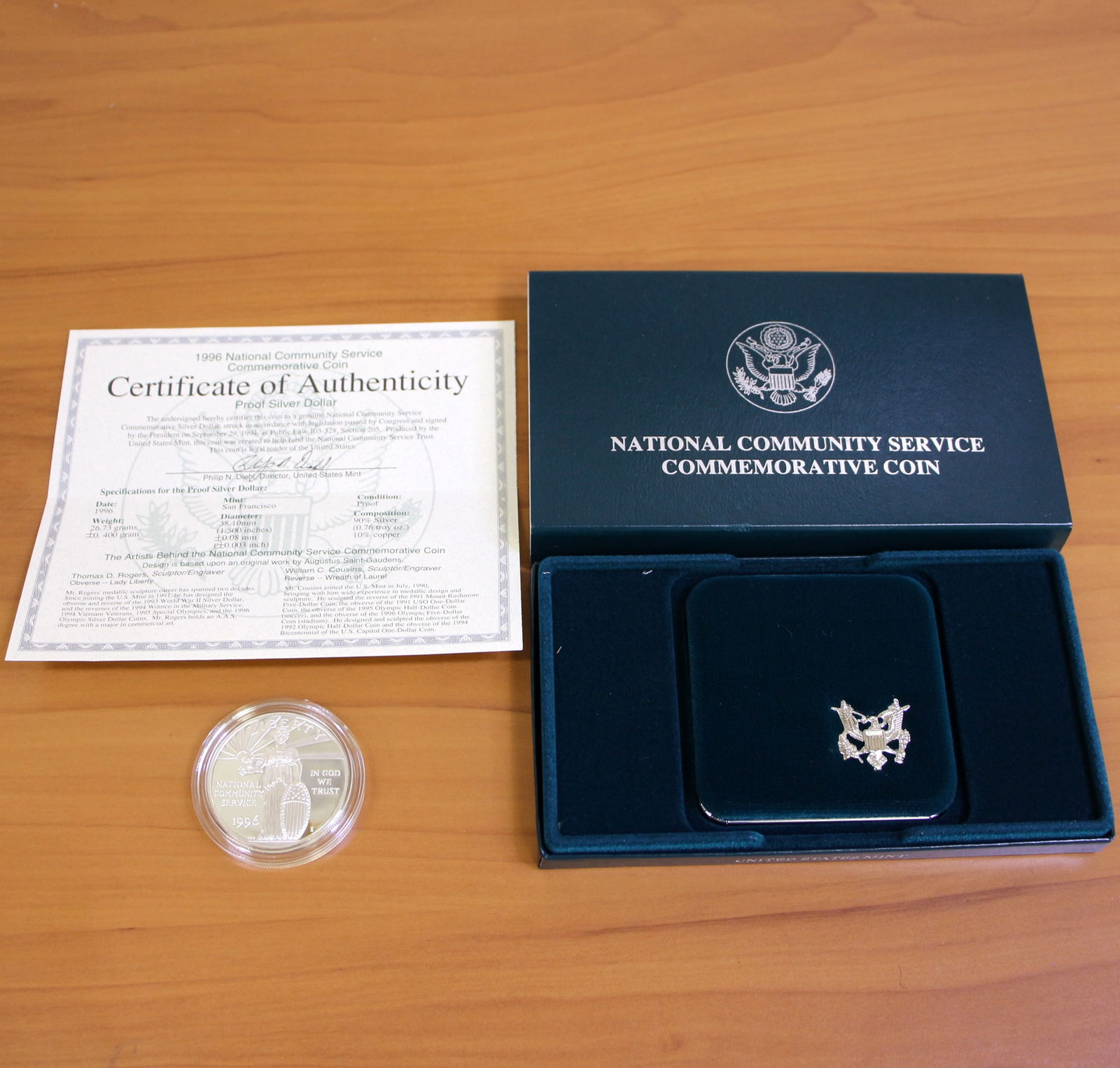 US Mint National Community Service Silver Dollar Proof Coin OGP: Contains one 1996 United States Mint 90% Silver Commemorative Silver Dollar. Set in original packaging and contains certificate of authenticity.