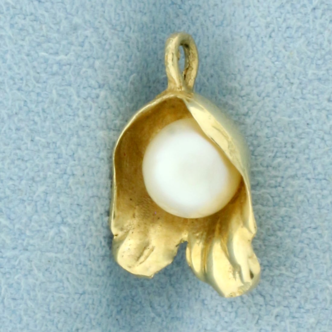 Cultured Akoya Pearl Flower Pendant in 14k Yellow Gold: In 14k Yellow Gold. Contains one 6.5mm high quality cultured Akoya pearl with high luster. 5/8 inch long including bale. 3/8 inch wide. 1.6g.