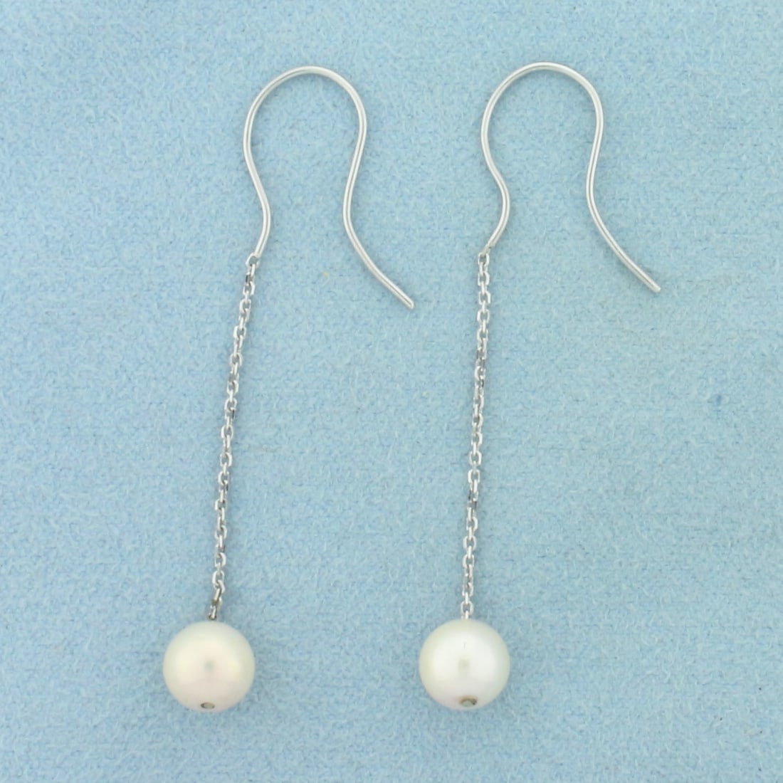 Akoya Pearl Dangle Earrings in 14k White Gold: In 14k White Gold. Contains two 7mm high quality Cultured Akoya Pearl gemstones with high luster. 2 inches long. Hook backs. 1.6g.