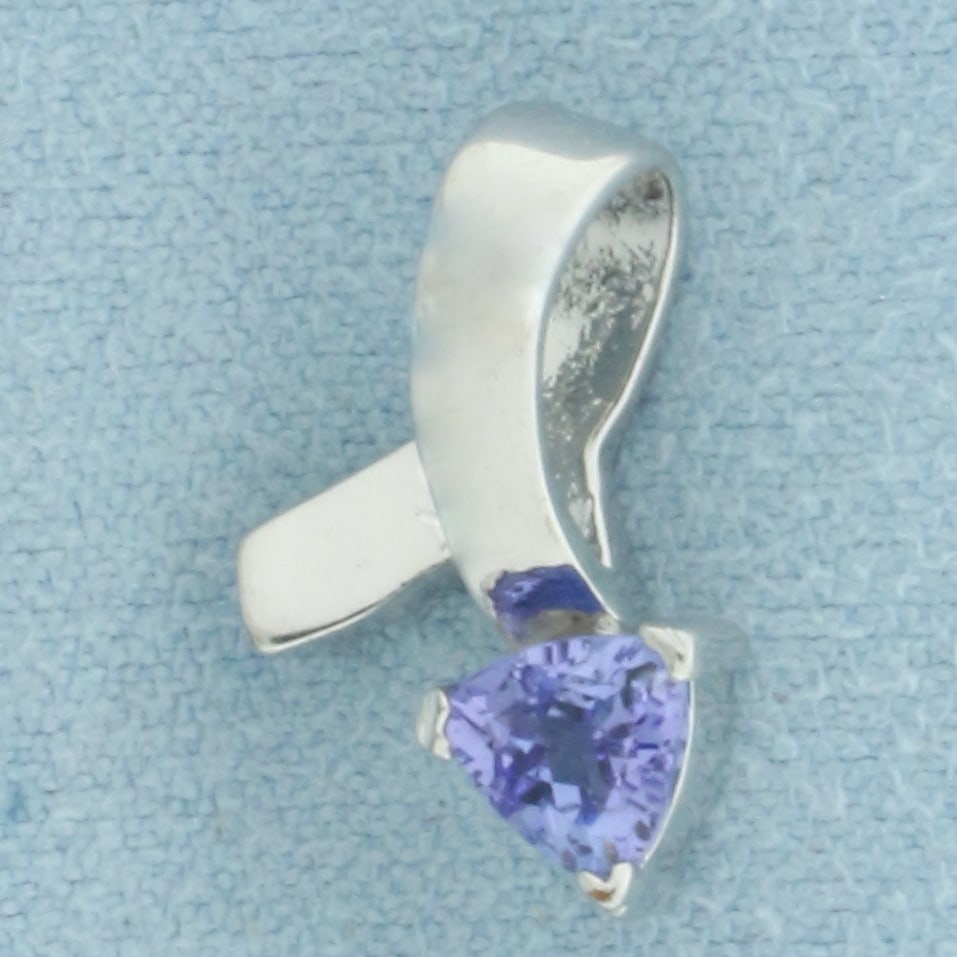 Lab Tanzanite Pendant: Gold plated Contains one 5mm high quality trillion cut lab Tanzanite gemstone with rich color and excellent clarity. 5/8 inch long. 3/8 inch wide. 1.5g.