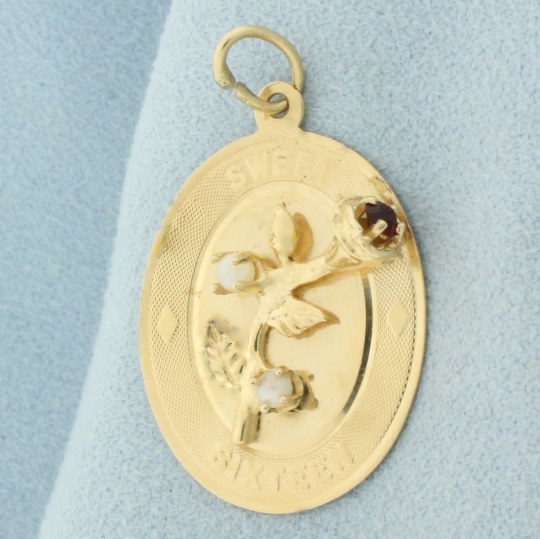 Sweet Sixteen Rose Pendant in 14k Yellow Gold: In 14k yellow gold. Contains one high quality natural 2.75mm garnet gemstone with intense color and two 2mm seed pearls . 1 1/4 inches long and 3/4 inches wide. 2.8g.