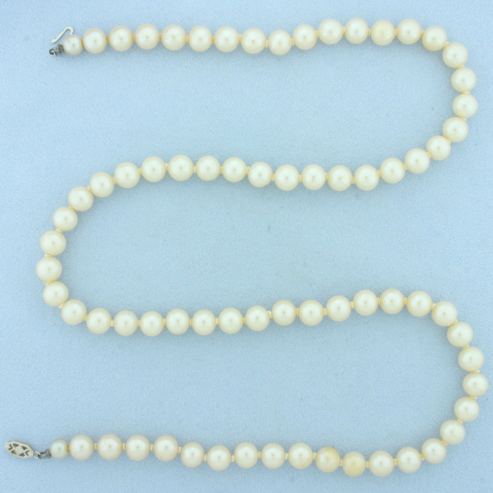 Vintage Akoya Pearl Strand Necklace With 10k White Gold Filigree Clasp: In 10k White Gold Filigree Clasp. Contains high quality 7.75-8m cultured akoya pearls with high luster. 24 inches long. Hand knotted.