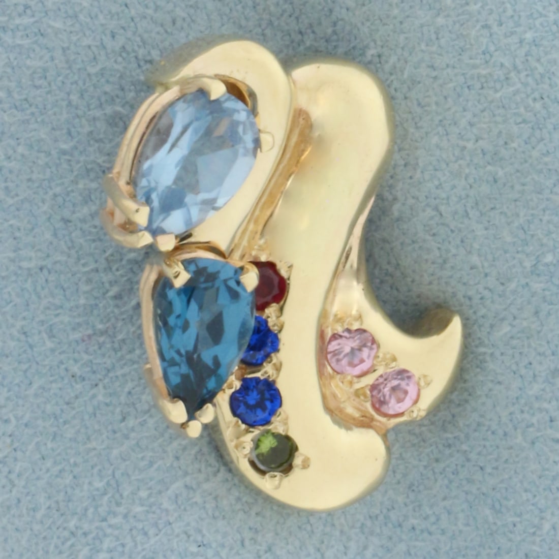 Rainbow Topaz Pendant or Slide in 14k Yellow Gold: In 14k Yellow Gold. Contains two 5x8mm pear cut and four 2mm round high quality Topaz gemstones with intense color and excllent clarity. 7/8 inch long. 3/4 inch wide. 8.3g.