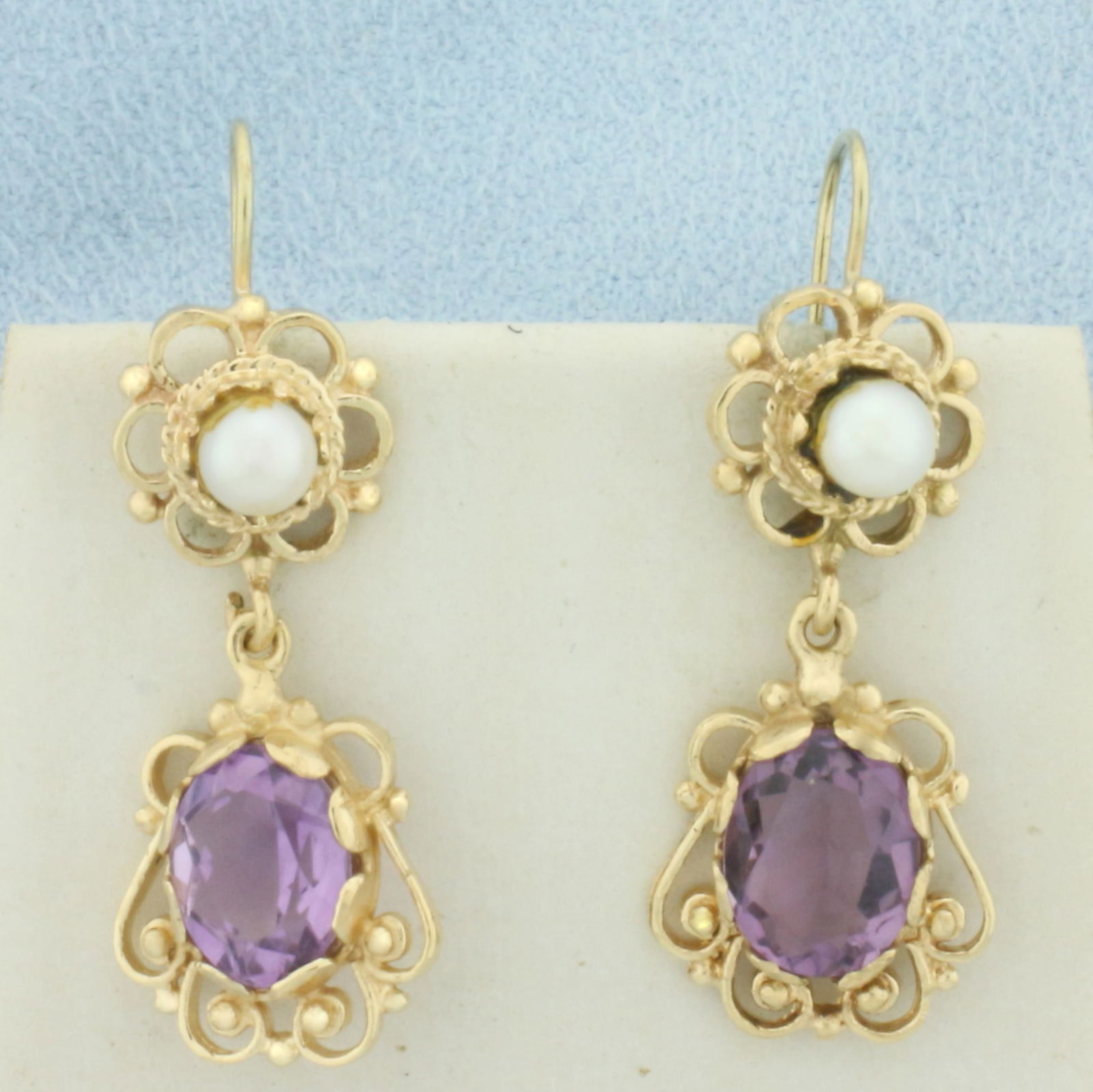Amethyst and Cultured Pearl Dangle Earrings in 14k Yellow Gold: In 14k Yellow Gold. Contains two 10x7mm high quality natural Amethyst gemstones with bright color and excellent clarity. Also contains two 4mm high quality Cultured Pearls with high luster. 1 1/4