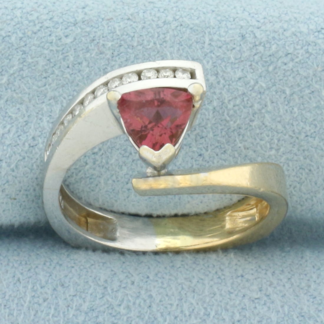 Morganite and Diamond Bypass Ring in 14k Yellow and White Gold: In 14k Yellow and White Gold. Contains one 6.5mm high quality trillion Morganite gemstone, approximately 1ct, with vibrant salmon color and excellent clarity. Also contains twelve .01ct high quality d