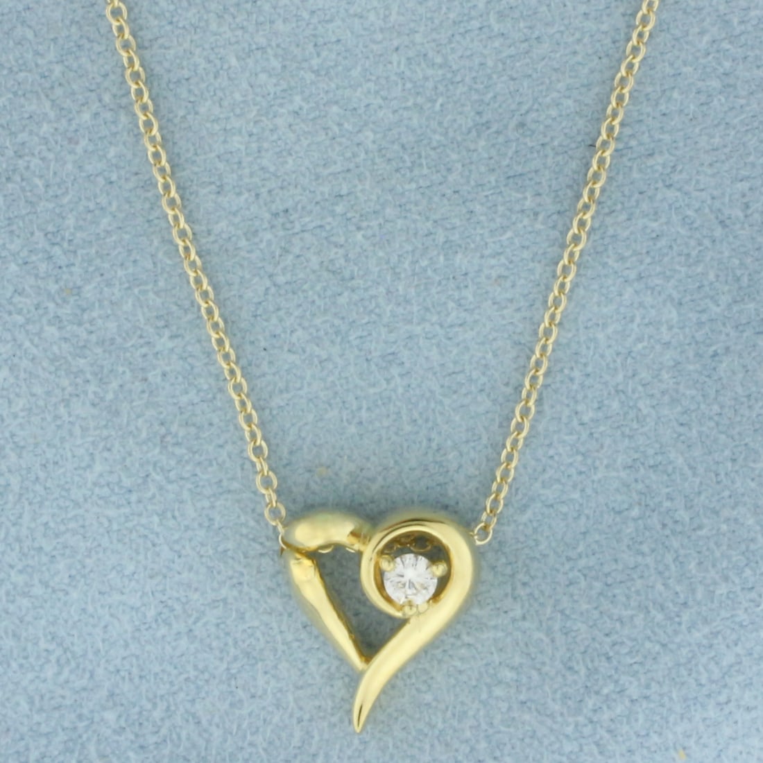 Diamond Heart Necklace in 14k Yellow Gold: In 14k Yellow Gold. Contains one .08ct high quality diamond, VS clarity/G color. Heart pendant is 1/2 inch long by 3/8 inch wide. Cable link chain is 15 inches long, 1mm wide. Spring clasp. 3.2g.