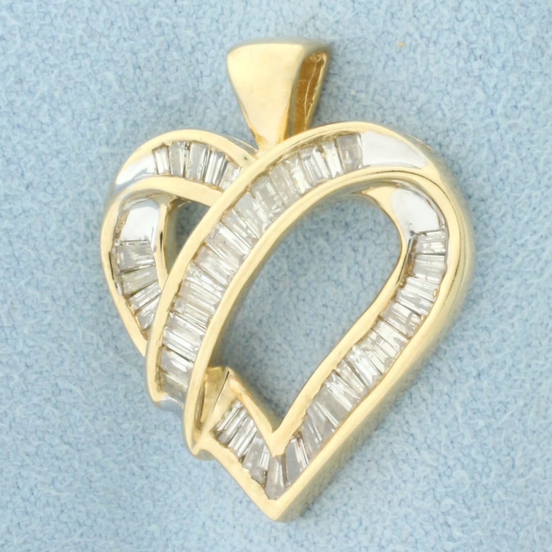 1ct Baguette Diamond Heart Pendant in 10k Yellow Gold: In 10k Yellow Gold. Contains forty-four high quality baguette diamonds, 1ct TW, I color/I clarity 1 inch long. 7/8 inch wide. 4.0g.