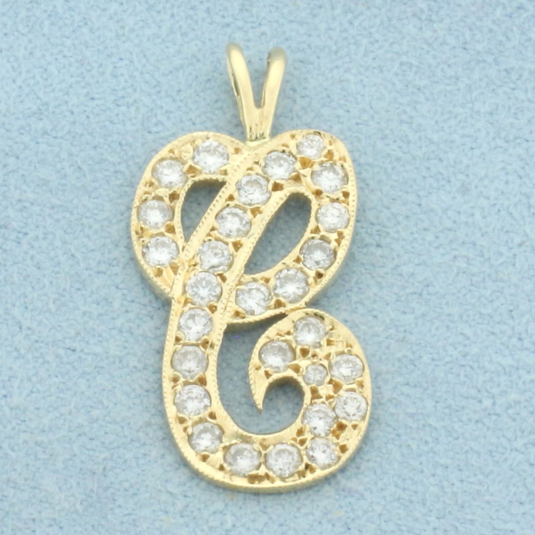 Diamond C Initial Pendant in 14k Yellow Gold: In 14k Yellow Gold. Contains twenty-eight high quality diamonds, 3/4ct TW, VS clarity/G color. 1 inch long. 1/2 inch wide. 2.0g.