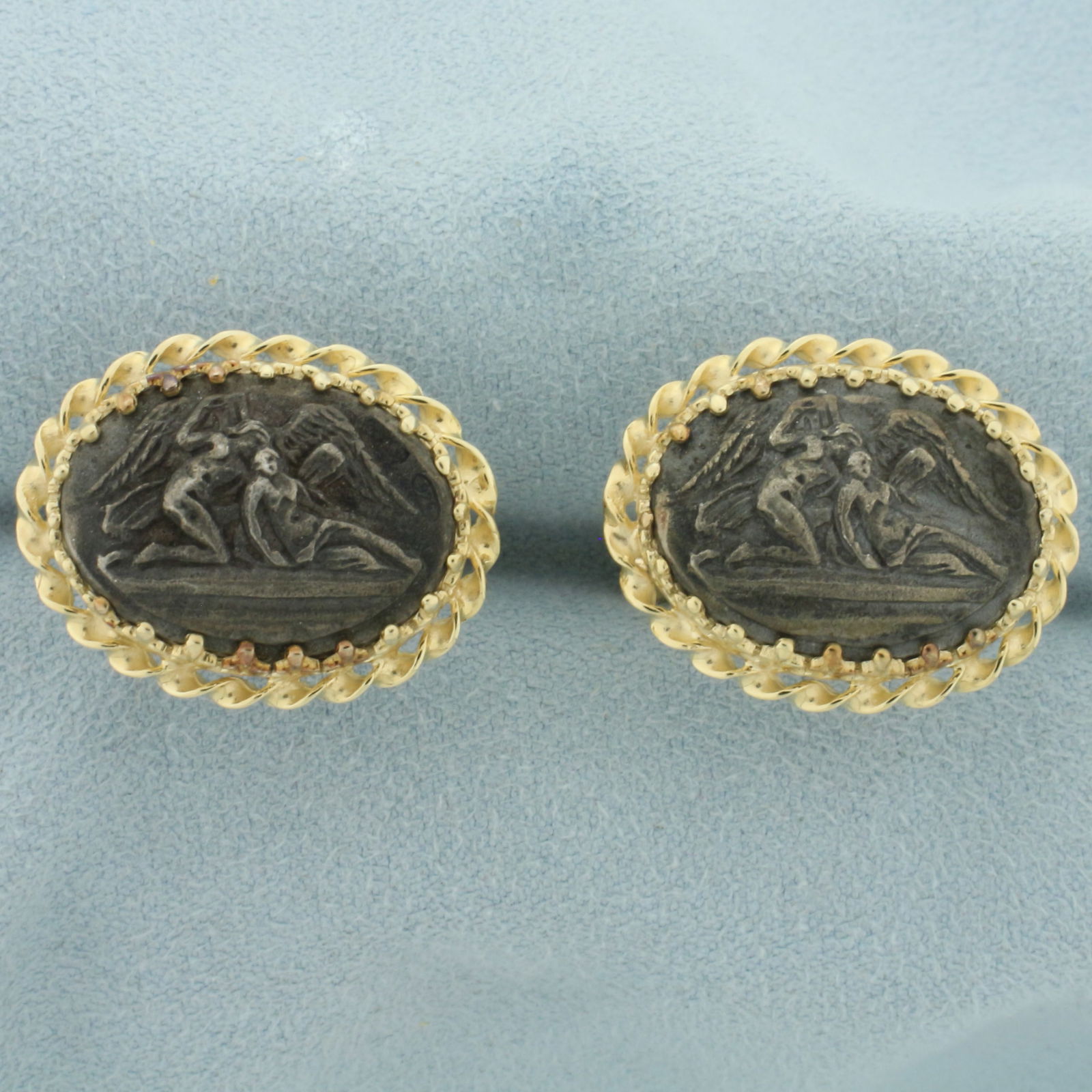 Guardian Angel Cufflinks in 14k Yellow Gold: In 14k yellow gold with Sterling Silver Cameo. 7/8 inches wide x 5/8 inches wide. 12.4g.