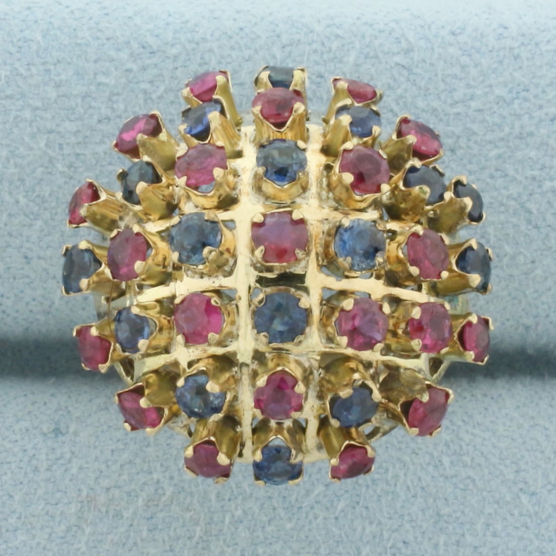 Ruby and Sapphire Sputnik Bombe Cocktail Ring in 9k Yellow Gold: In 9k Yellow Gold. Contains thirty seven high quality natural 2.5 to 3mm Ruby and Sapphire gemstones with vibrant color and excellent clarity. 3.5ct TW. 22.4mm diameter. Size 7. 5.5g.