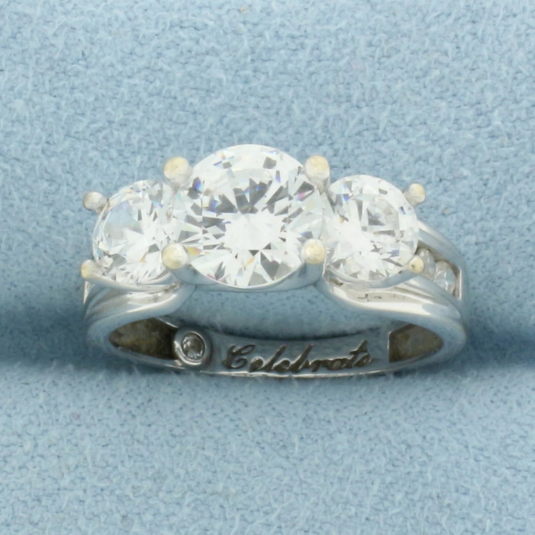 CZ Engagement Ring in 14k White Gold: In 14k White Gold. Contains one 7.4mm, two 5.4mm, and six 2.2mm high quality Cubic Zirconia gemstones, all with excellent cut and clarity for added brilliance. Size 6.5. 4.8g.