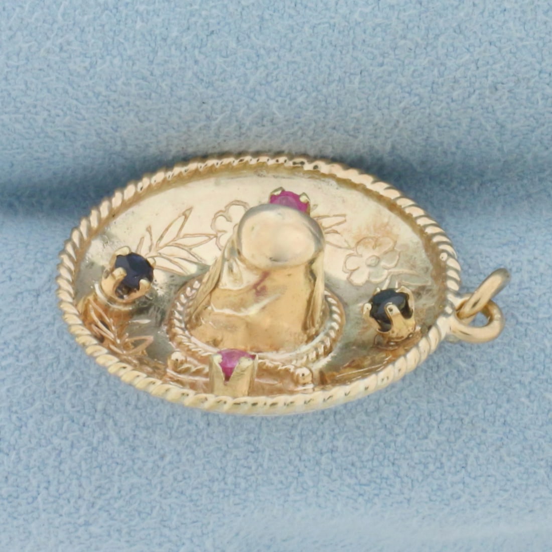 Ruby and Sapphire Sombrero Hat Charm in 14k Yellow Gold: In 14k Yellow Gold. Contains two 2mm Ruby and two 2mm Sapphire high quality gemstones with vibrant color and excellent clarity. 1 1/8 inch long. 1 inch wide. 3.7g.