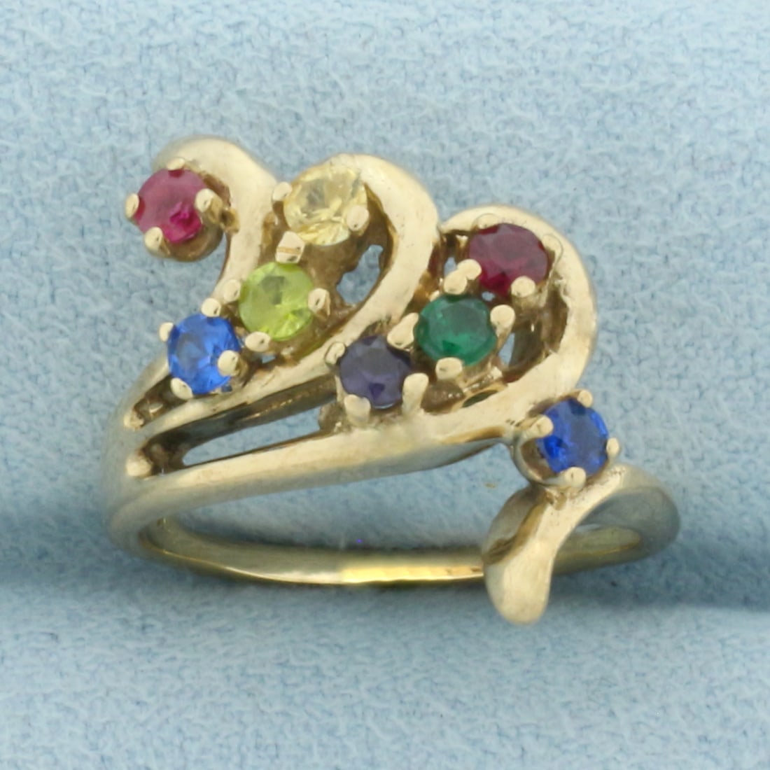 Multi-Gemstone Wave Ring in 14k Yellow Gold: In 14k Yellow Gold. Contains high quality natural 2.5mm gemstones including Ruby, Sapphire, Topaz, Amethyst, Green Garnet, Citrine, and Peridot. 18mm wide. Size 5.5. 4.6g.