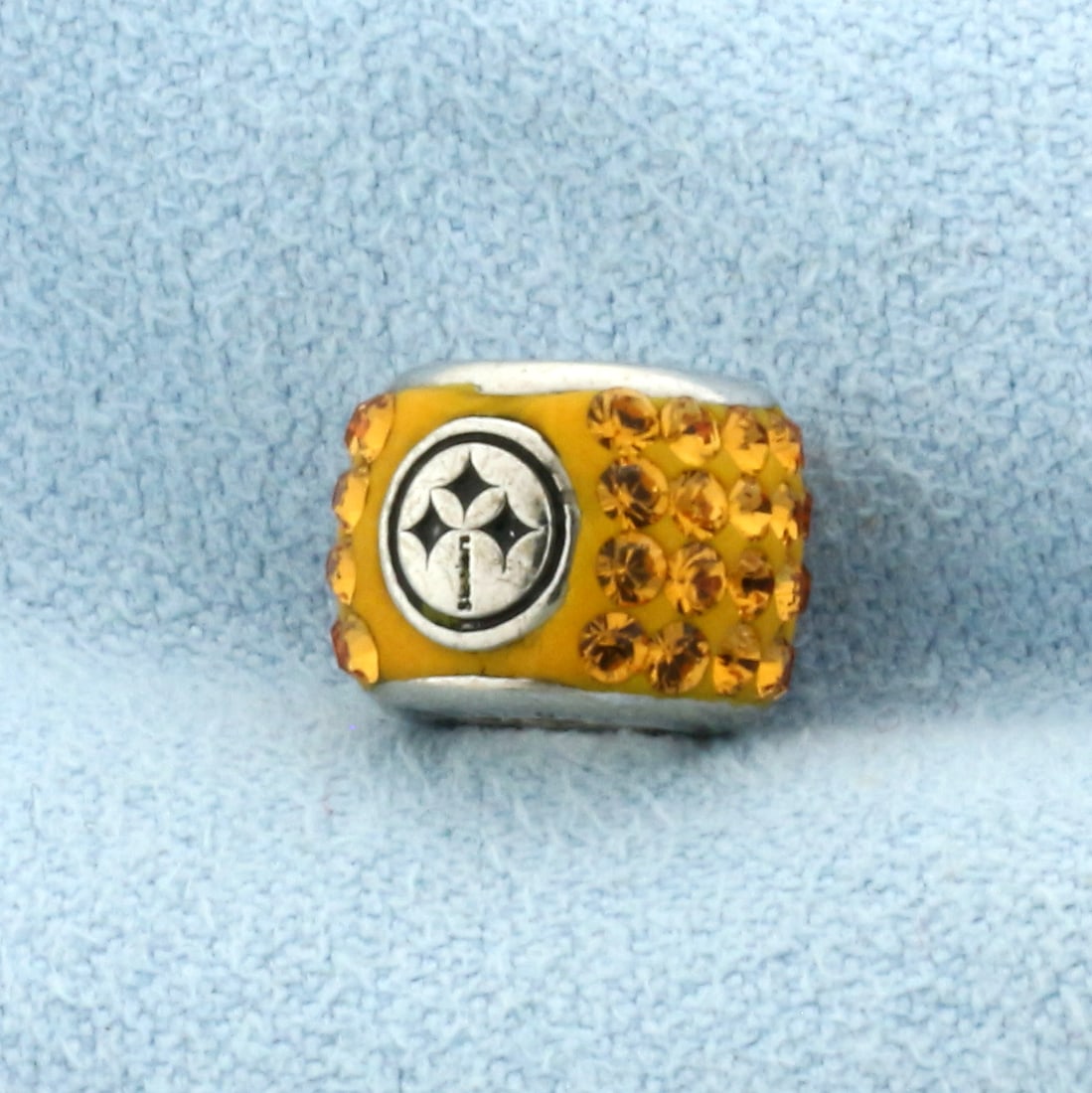 Steelers Sterling Silver Football Charm Bracelet Bead: In .925 Sterling Silver. 10mm diameter. Fits standard charm bracelets (like Pandora). Accented with Steelers logo and Cubic Zirconia gemstones. 2.2g.