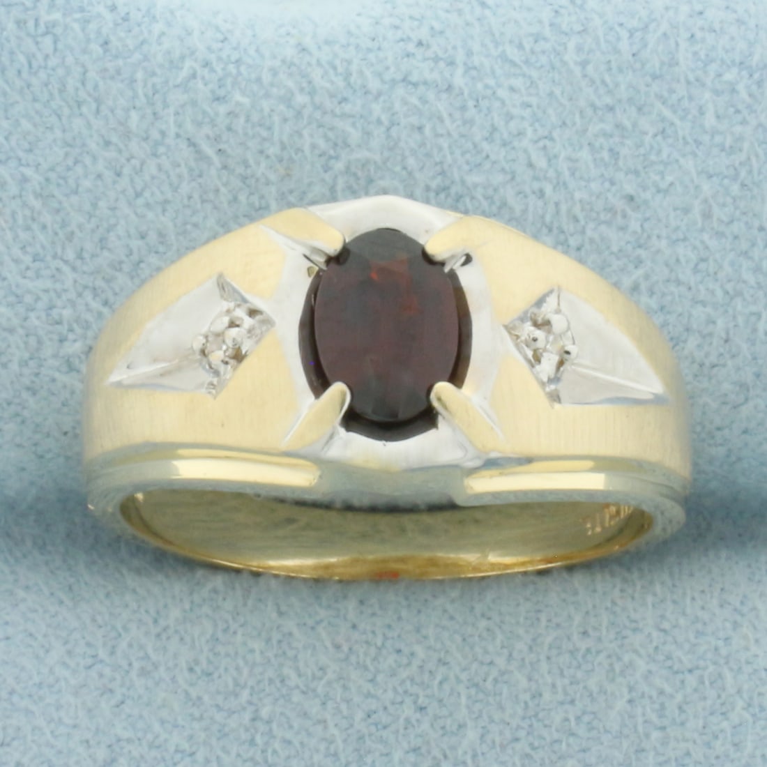 Mens Garnet and Diamond Ring in 10k Yellow and White Gold: In 10k Yellow and White Gold. Contains one 5x7mm high quality natural Garnet gemstone, approximately 1ct, with intense color and excellent clarity. Also contains two .01ct high quality diamonds, SI cl