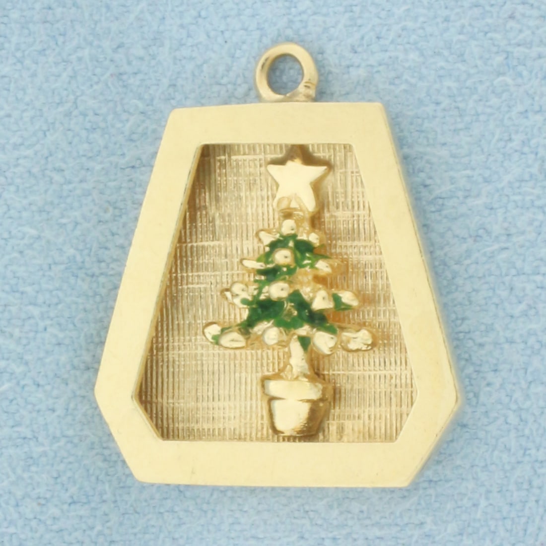 Christmas Tree Charm in 14k Yellow Gold: In 14k Yellow Gold. 3/4 inch long. 3/4 inch wide. Green enamel details. 2.1g.