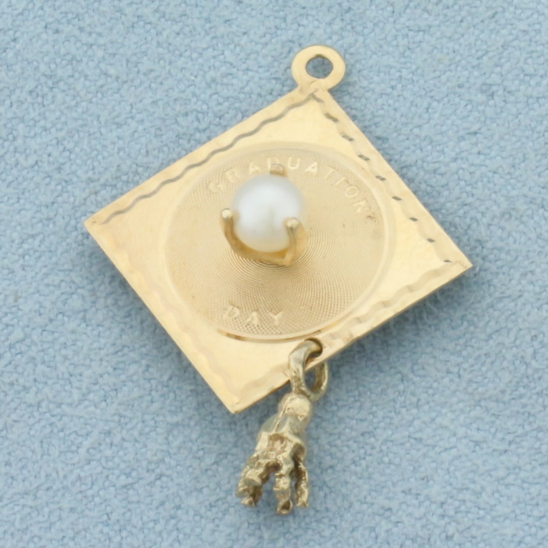 Graduation Day Mortarboard Cap Charm in 14k Yellow Gold: In 14k Yellow Gold. Contains one high quality 4.25mm cultured pearl with high luster. 1 1/8 inch long. 7/8 inch wide. 2.0g.