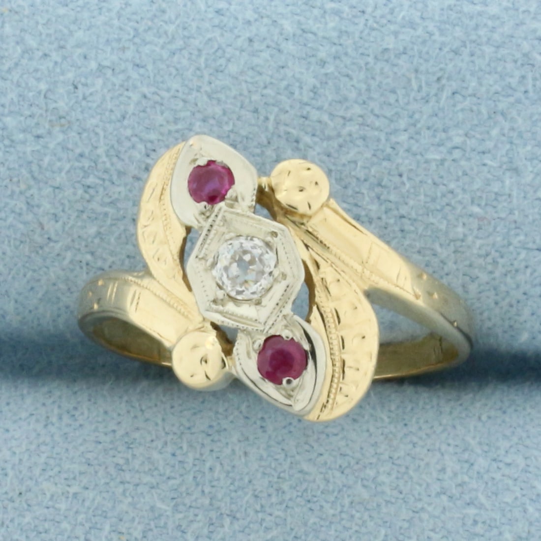 Antique Old European Cut Diamond and Ruby Ring in 14k Yellow Gold: In 14k Yellow Gold. Contains one 1/8ct old European cut diamond, VS clarity/H color. Also contains two 2mm high quality natural Ruby gemstones with intense color. 14mm wide spread at top of ring. Size