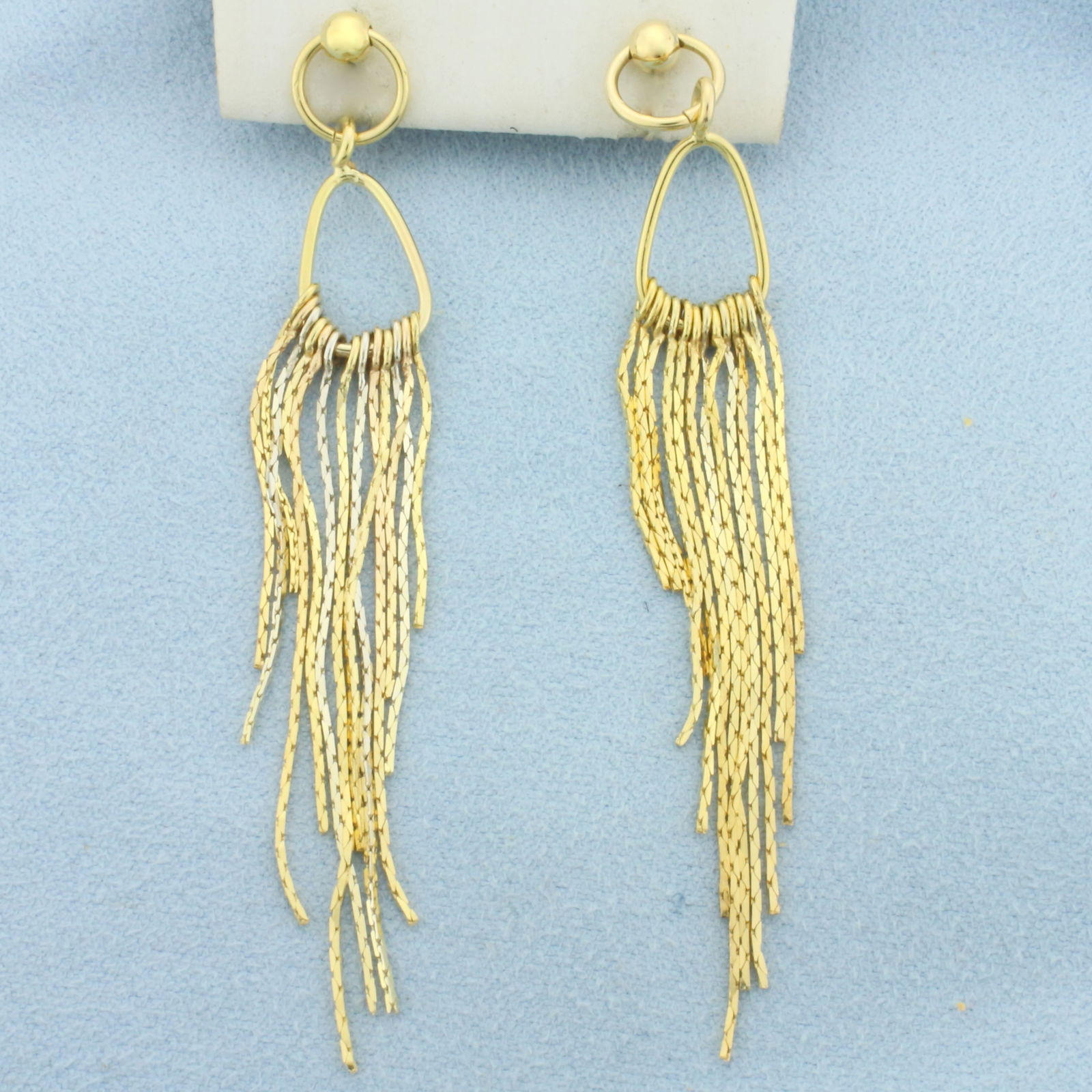 Dangle Chain Chandelier Earrings in 14k Yellow and White Gold: In 14k Yellow and White Gold. 3 inches long. 3/8 inch wide. Friction backs. 5.7g.