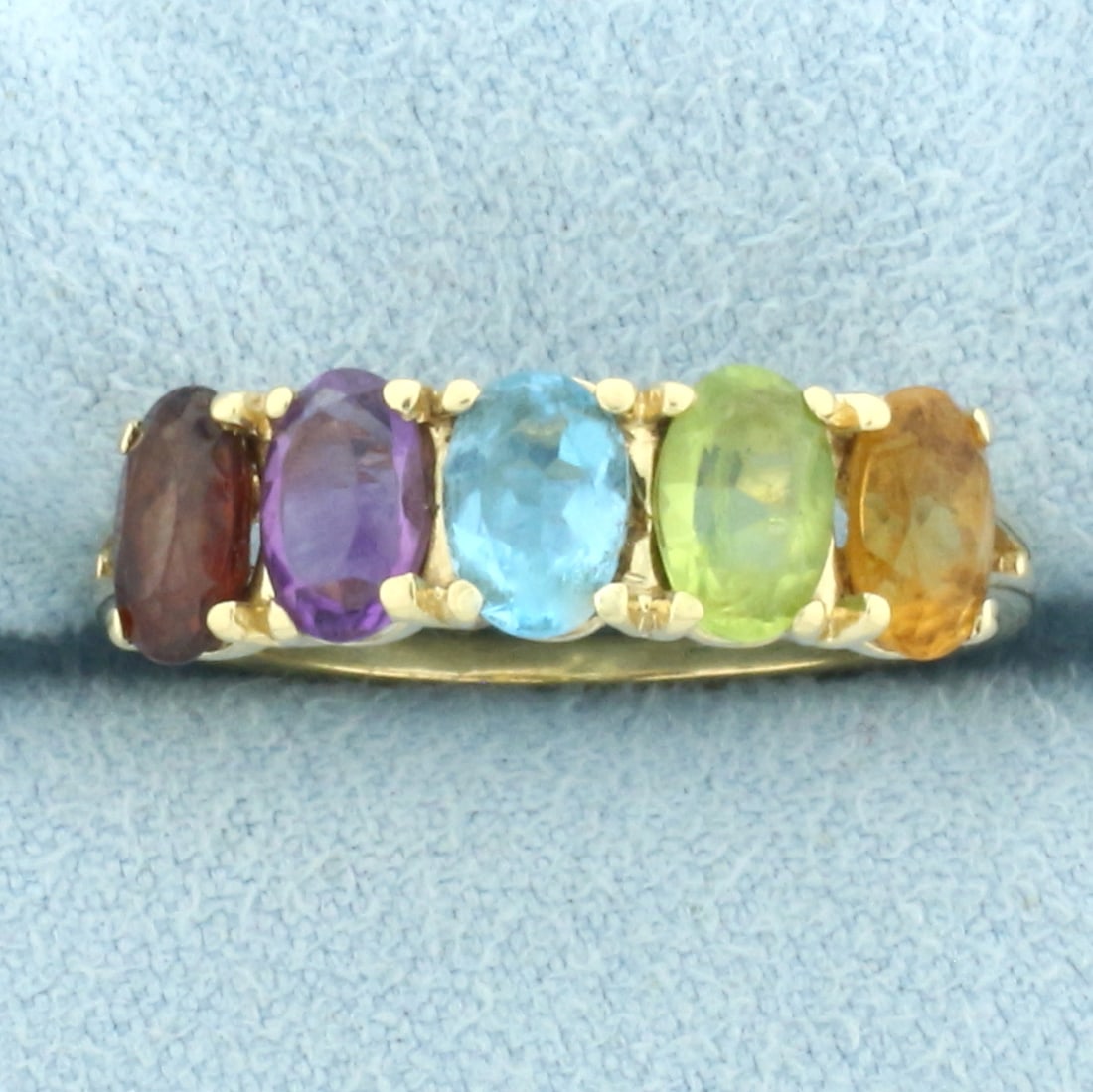 Rainbow Gemstone Ring in 14k Yellow Gold: In 14k Yellow Gold. Contains five high quality natural 6mmx4mm gemstones: garnet, amethyst, blue topaz, peridot, and citrine, all with intense color and excellent clarity. Size 8. 3.3g.