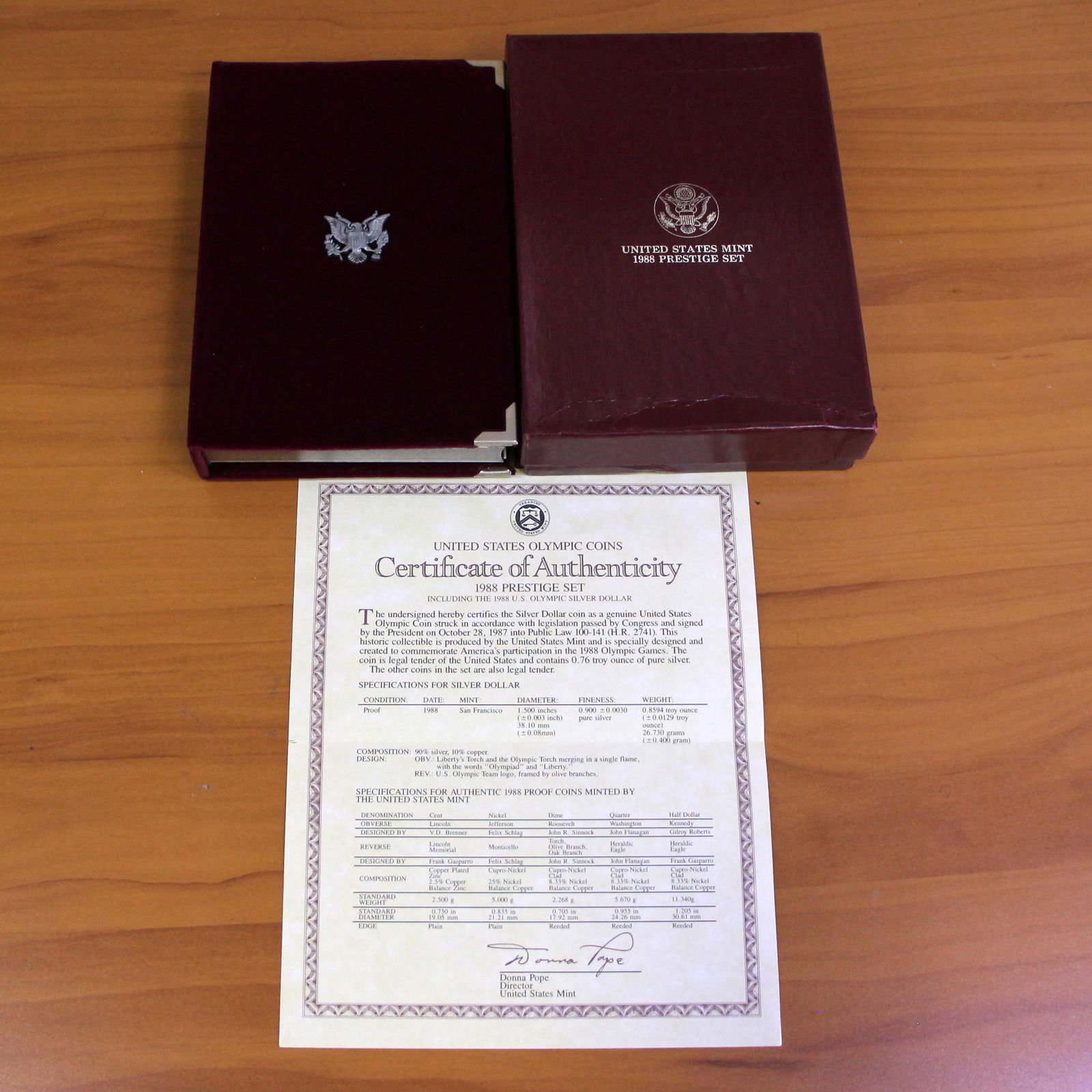 US Mint Olympic Prestige Coin Set OGP: 1988 United States Mint Olympic Prestige Set including one 1988 90% Silver Olympic Silver Dollar. Set in original packaging and contains certificate of authenticity.