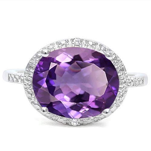Amethyst and Diamond Oval Halo Statement Ring in Sterling Silver: In platinum over .925 sterling silver. Contains one oval cut amethyst gemstone, 4.2cts, accented with two genuine diamond, .01ctw. Size 8. 3.3g