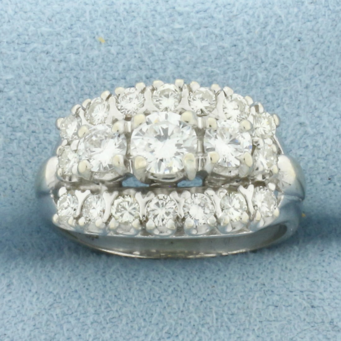 Vintage Diamond Ring in 14k White Gold: In 14k White Gold. Contains one .4ct, two .2ct, and sixteen .05ct high quality round brilliant diamonds, SI clarity/H color. 11.6m wide at top of ring. Size 7.75. 6.4g.