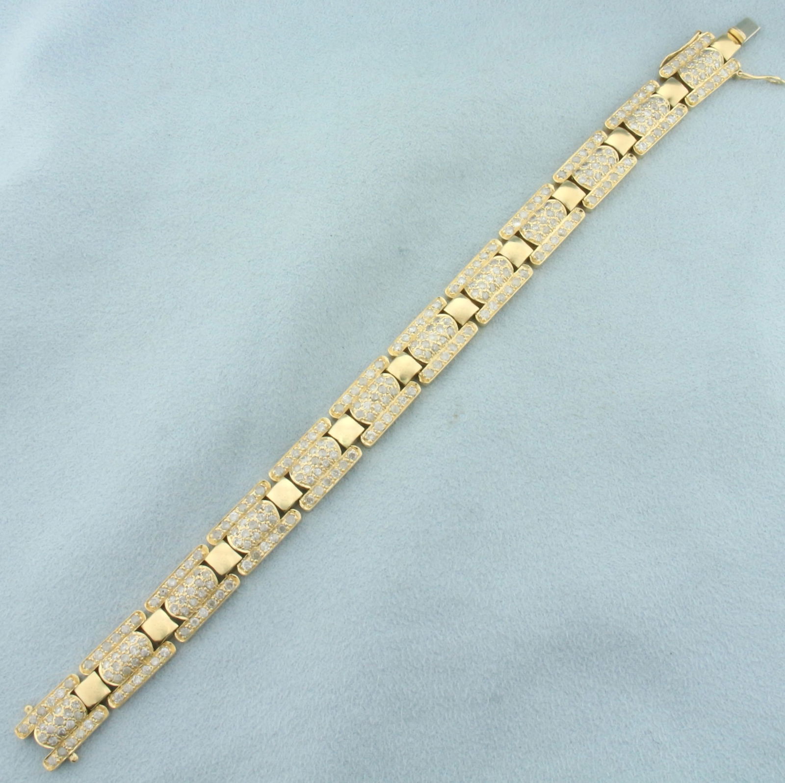 3ct Diamond Track Link Bracelet in 14k Yellow Gold: In 14k yellow gold. Contains 300 high quality diamonds, 3ct TW, H color/I clarity. 7 inches long and 3/8 inches wide. Concealed slide clasp with double safety latch. 22.7g.