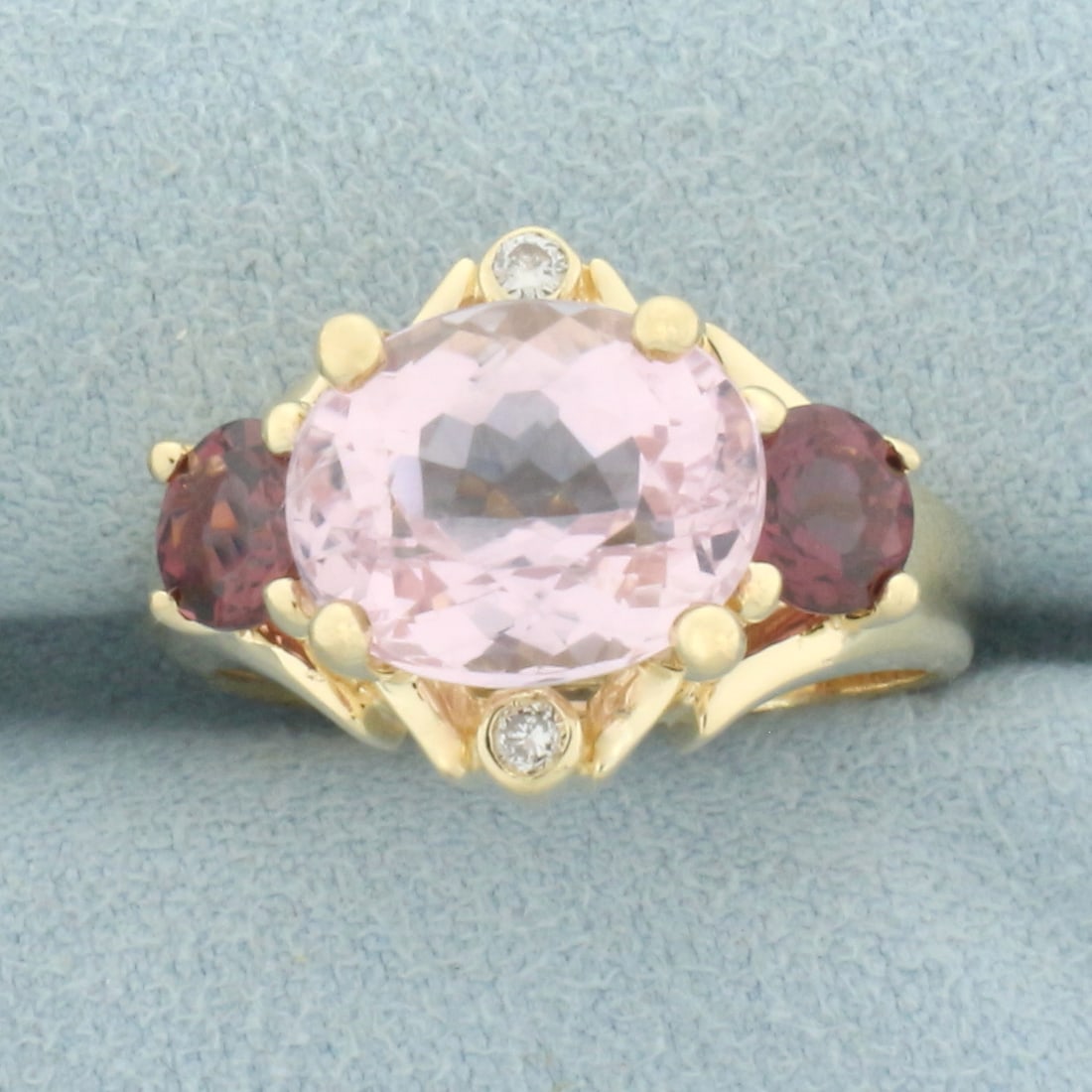 Morganite, Garnet, and Diamond Ring in 14k Yellow Gold: In 14k yellow gold. Contains 1 high quality 11mm by 9mm Morganite gemstone, approximately 4cts, with beautiful salmon color and excellent clarity. Also contains 2 high quality natural 5mm Garnet gemst