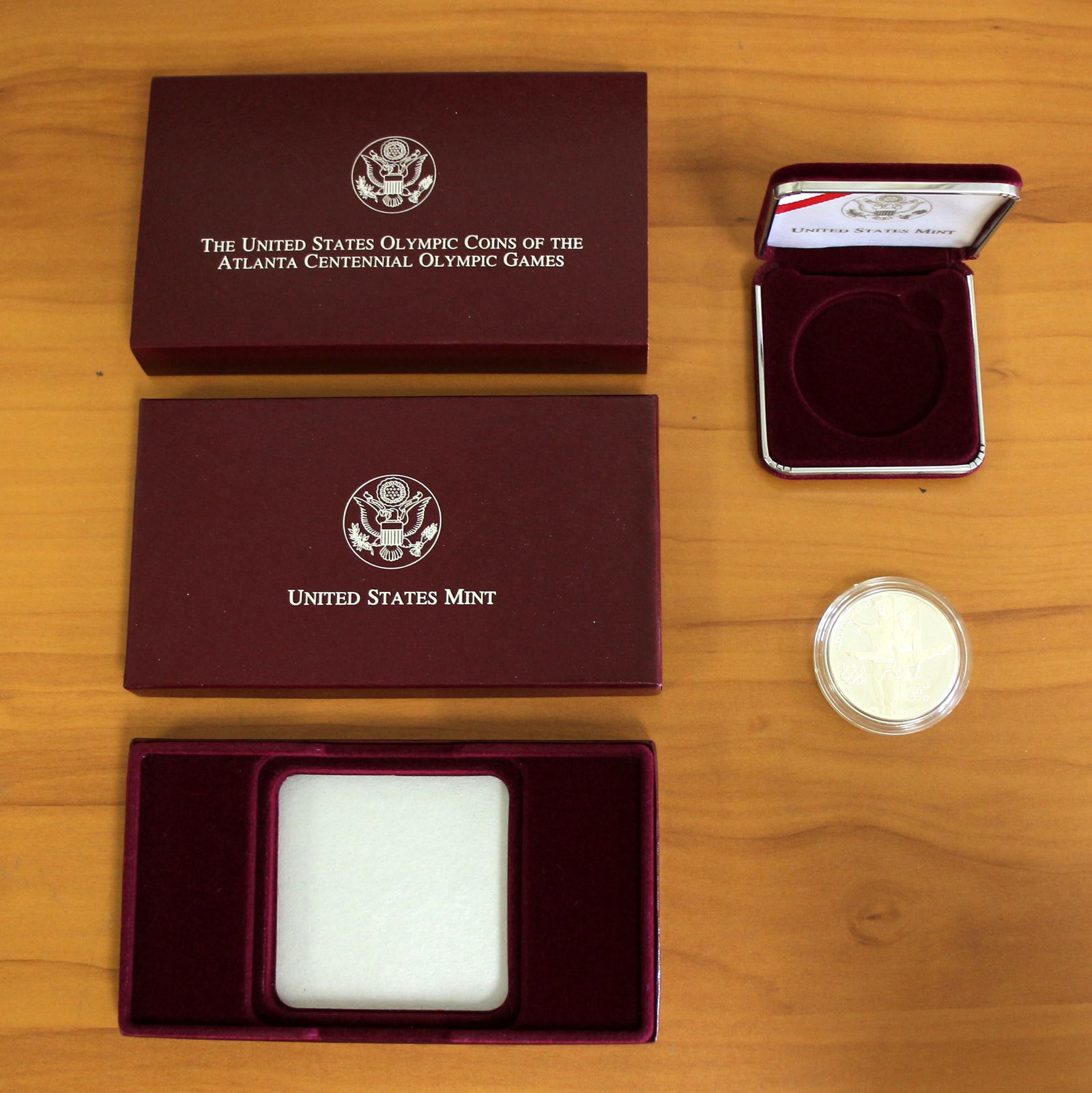 US Mint Atlanta Centennial Silver Olympic Proof Coin OGP: Contains one 1995 or 1996 U.S. Mint Atlanta Centennial 90% Silver Olympic Games Coin. Includes original box and packaging.