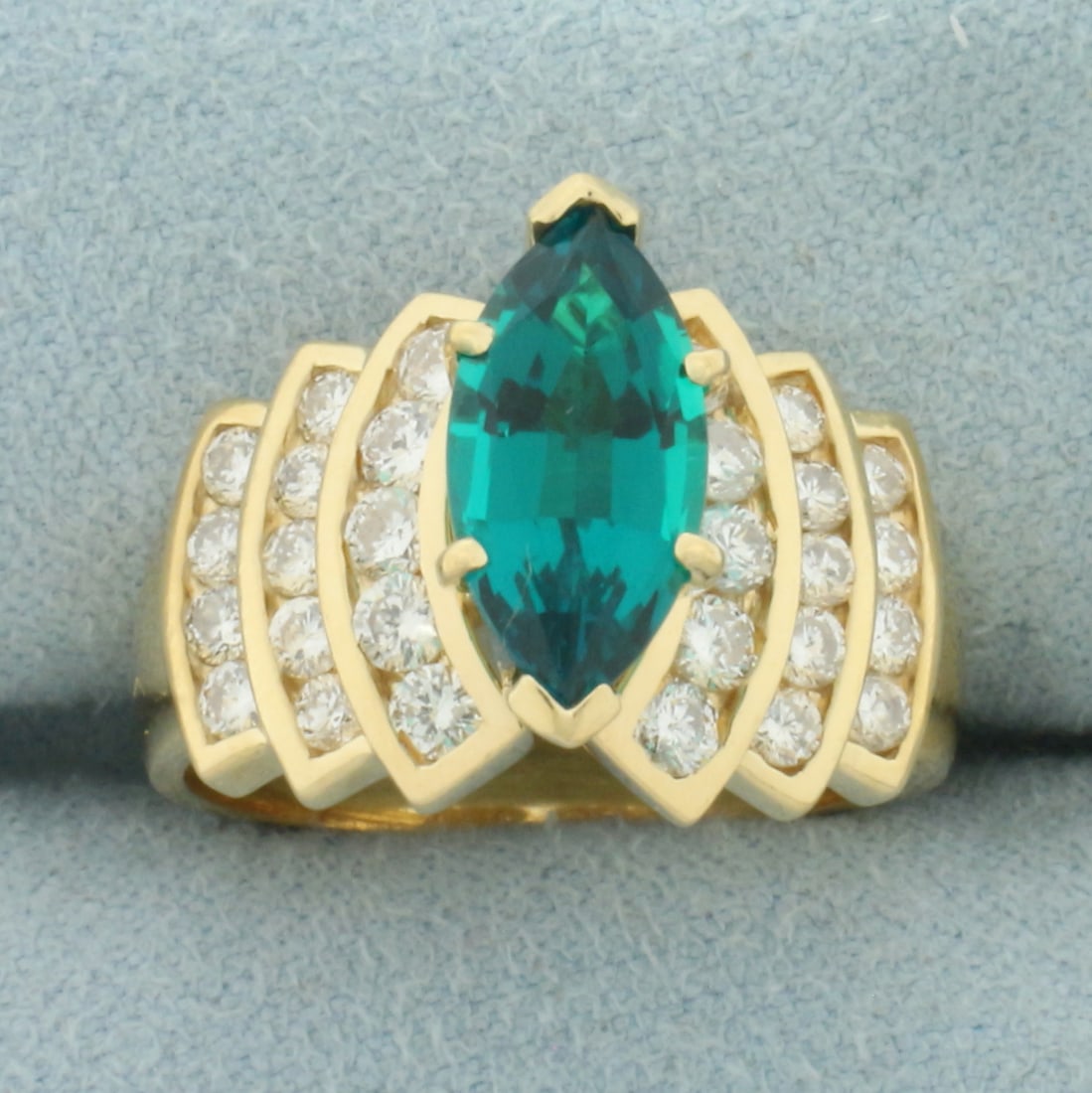 Tsavorite Garnet and Diamond Ring in 14k Yellow Gold: In 14k Yellow Gold. Contains one 12x6mm high quality natural Tsavorite Garnet gemstone, approximately 3cts, with intense color and excellent clarity. Also contains 28 high quality diamonds, 1ct TW, SI