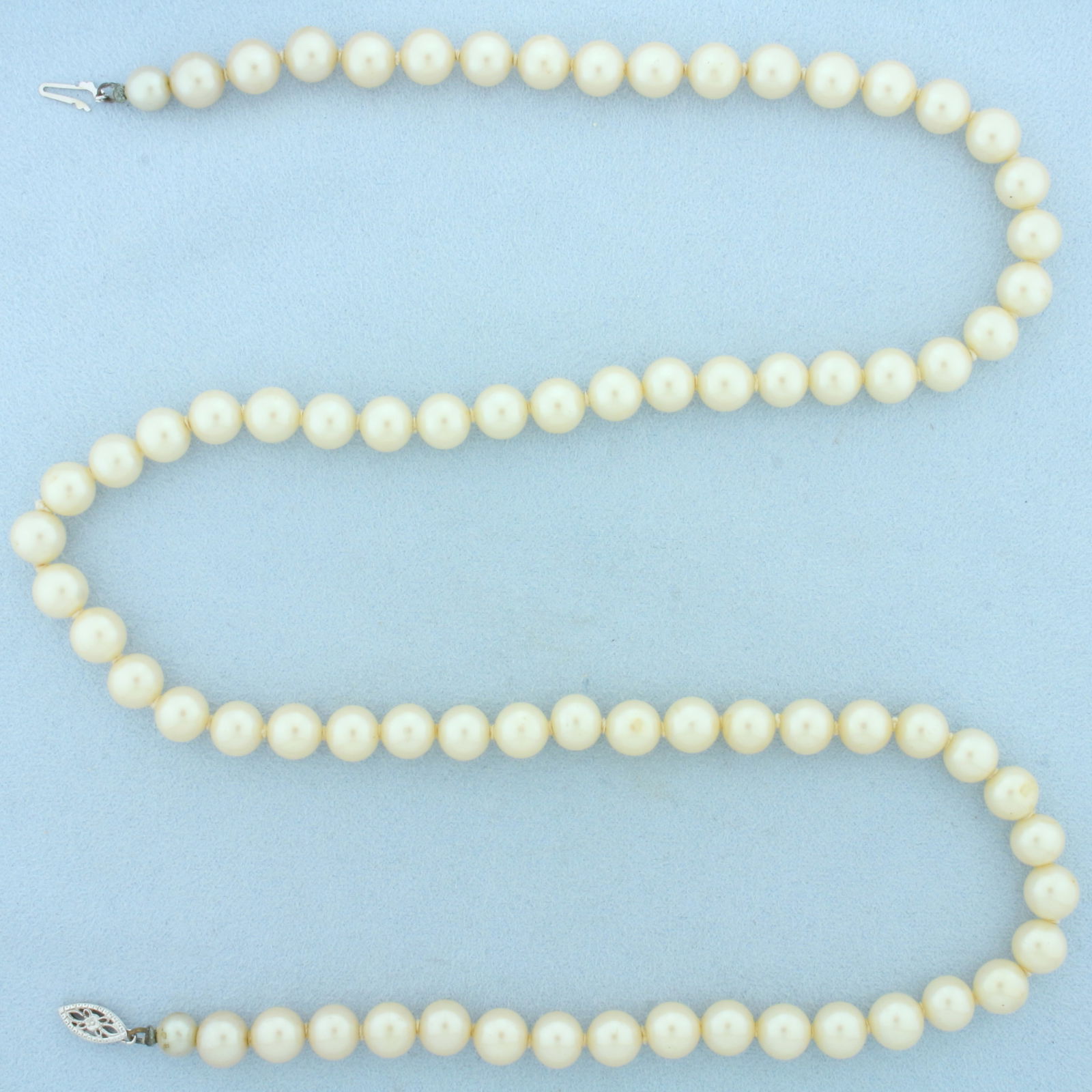 Vintage Akoya Pearl Strand Necklace in 14k White Gold Filigree Clasp: In 14k White Gold Filigree Clasp. Contains high quality 7.75-8mm cultured akoya pearls with high luster. 25 inches long. Hand knotted.
