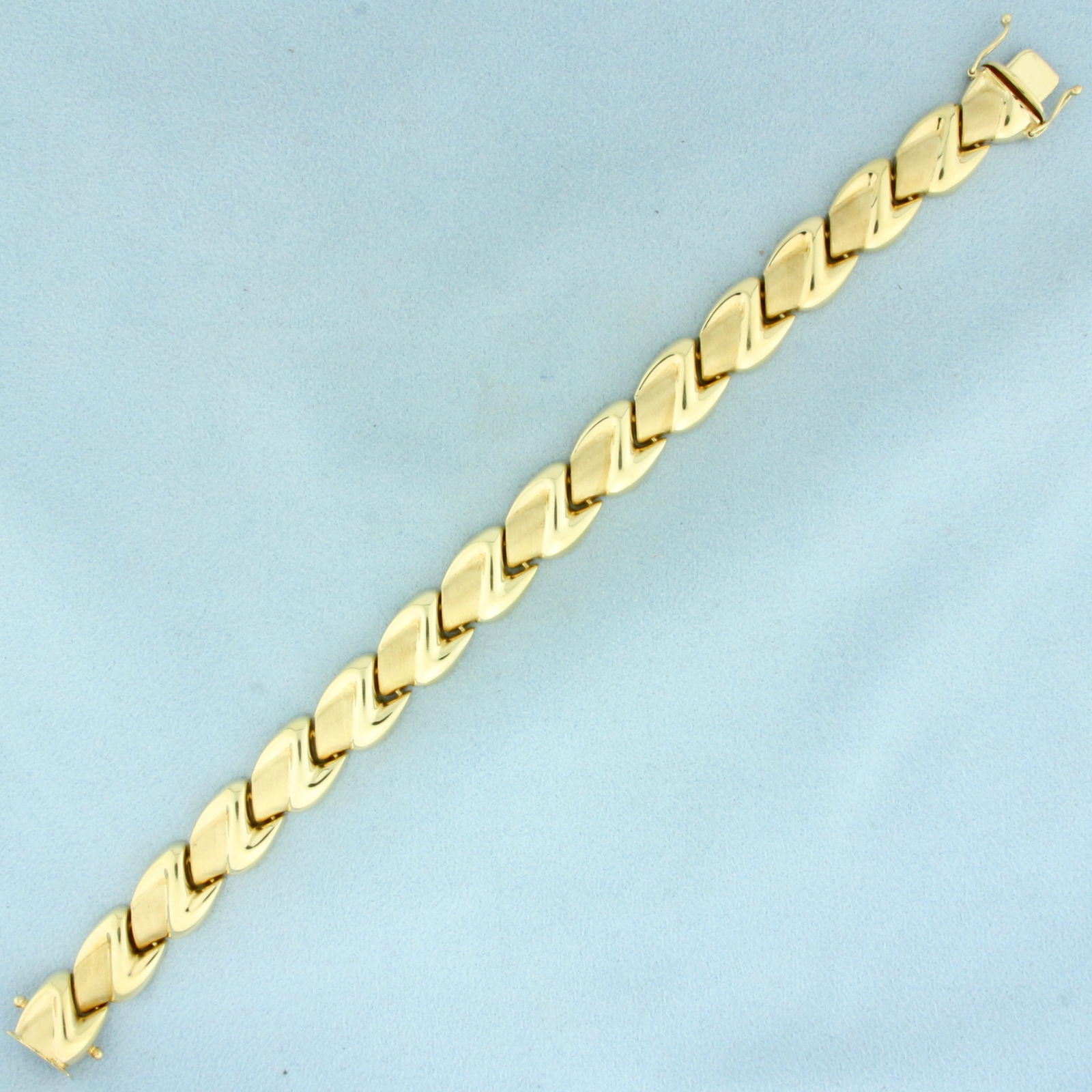 Italian Satin and High Polish Finish Abstract Bracelet in 14k Yellow Gold: In 14k Yellow Gold. 8 inches long. 12mm wide. Concealed slide clasp with two safety latches. 22.8g.