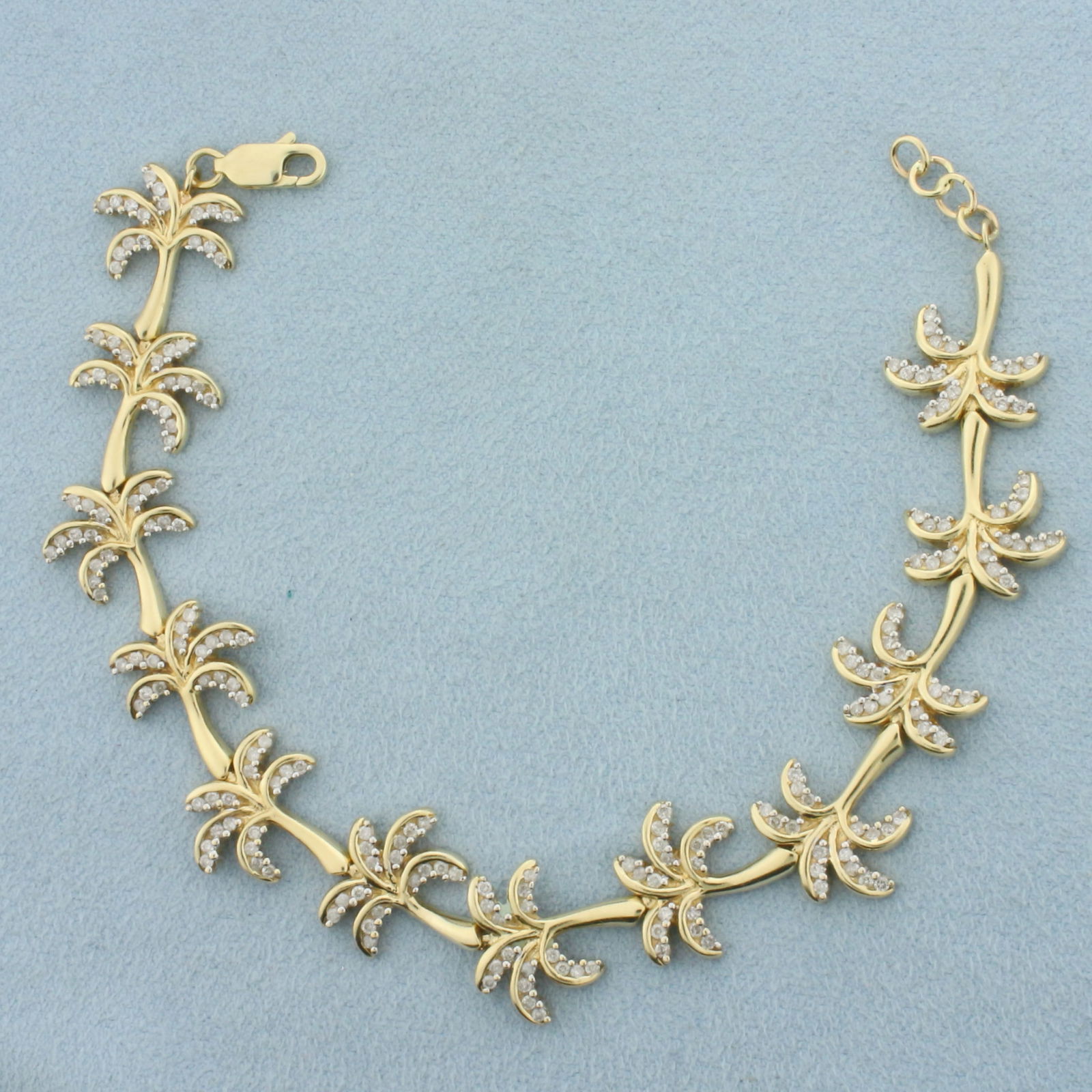 Diamond Palm Tree Link Bracelet in 14k Yellow Gold: In 14k Yellow Gold. Contains one hundred and eighty high quality diamonds, 1.5ct TW, SI clarity/H color. Adjustable length 7 to 7 3/8 inches long. 1/2 inch wide. Lobster clasp. 15.9g.