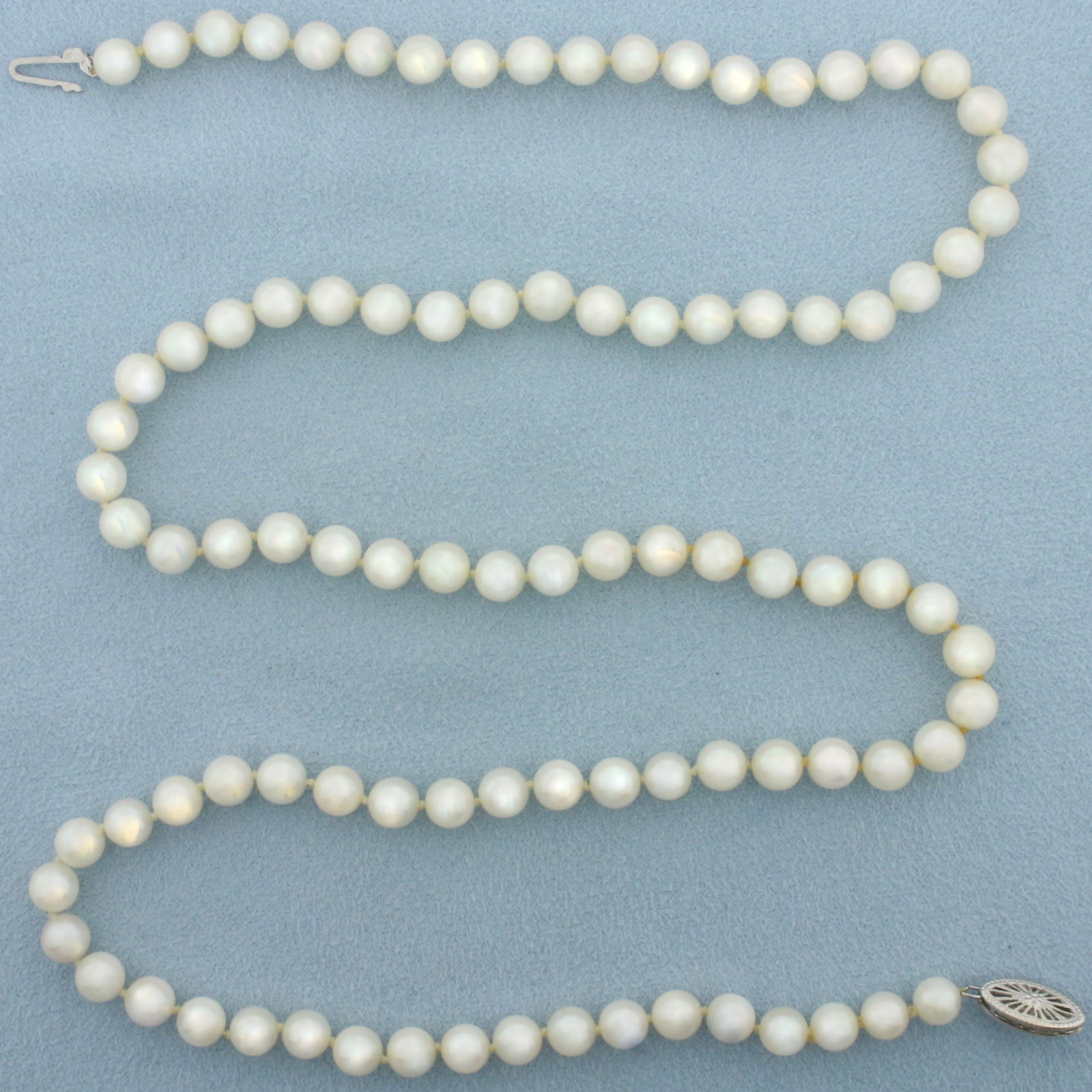 Cultured Akoya Pearl Strand Necklace with 14k White Gold Filigree Locking Clasp: 14k White Gold Filigree Locking Clasp. Contains high quality 6mm cultured akoya pearls with high luster. 24 inch long. Hand knotted. 26.7g.