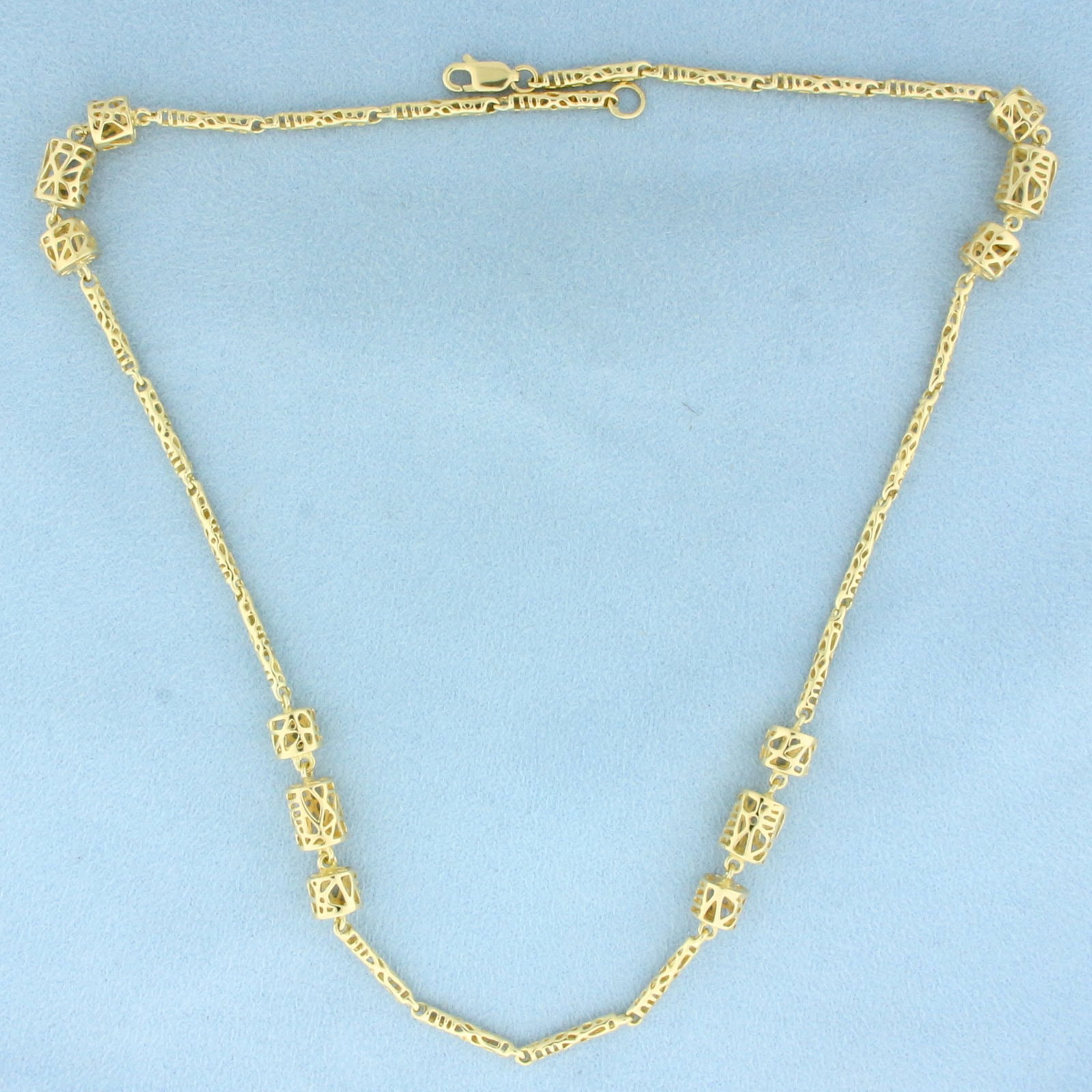18 Inch Designer Cage Link Chain Necklace in 14k Yellow Gold: In 14k Yellow Gold. 18 inches long. 7mm wide at widest. Lobster clasp. 19.1g.