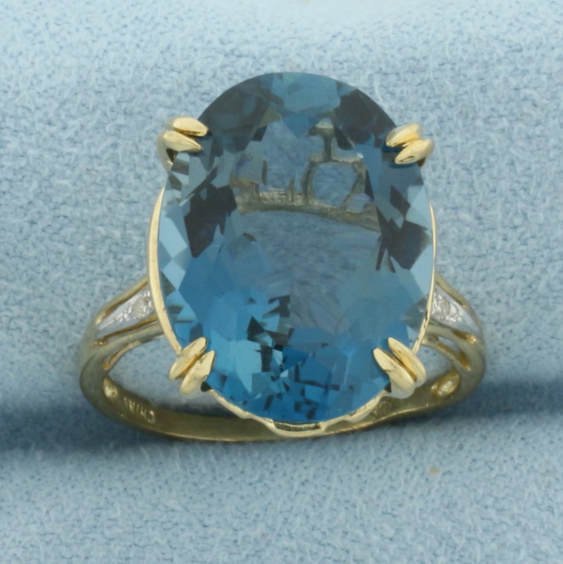 London Blue Topaz and Diamond Ring in 10K Yellow Gold: In 10k yellow gold. Contains a high quality 11ct London Blue Topaz gemstone, 18mm long, with intense color and excellent clarity. Accented by 6 high quality 1/2pt diamonds. Size 7.25. 4.6g.