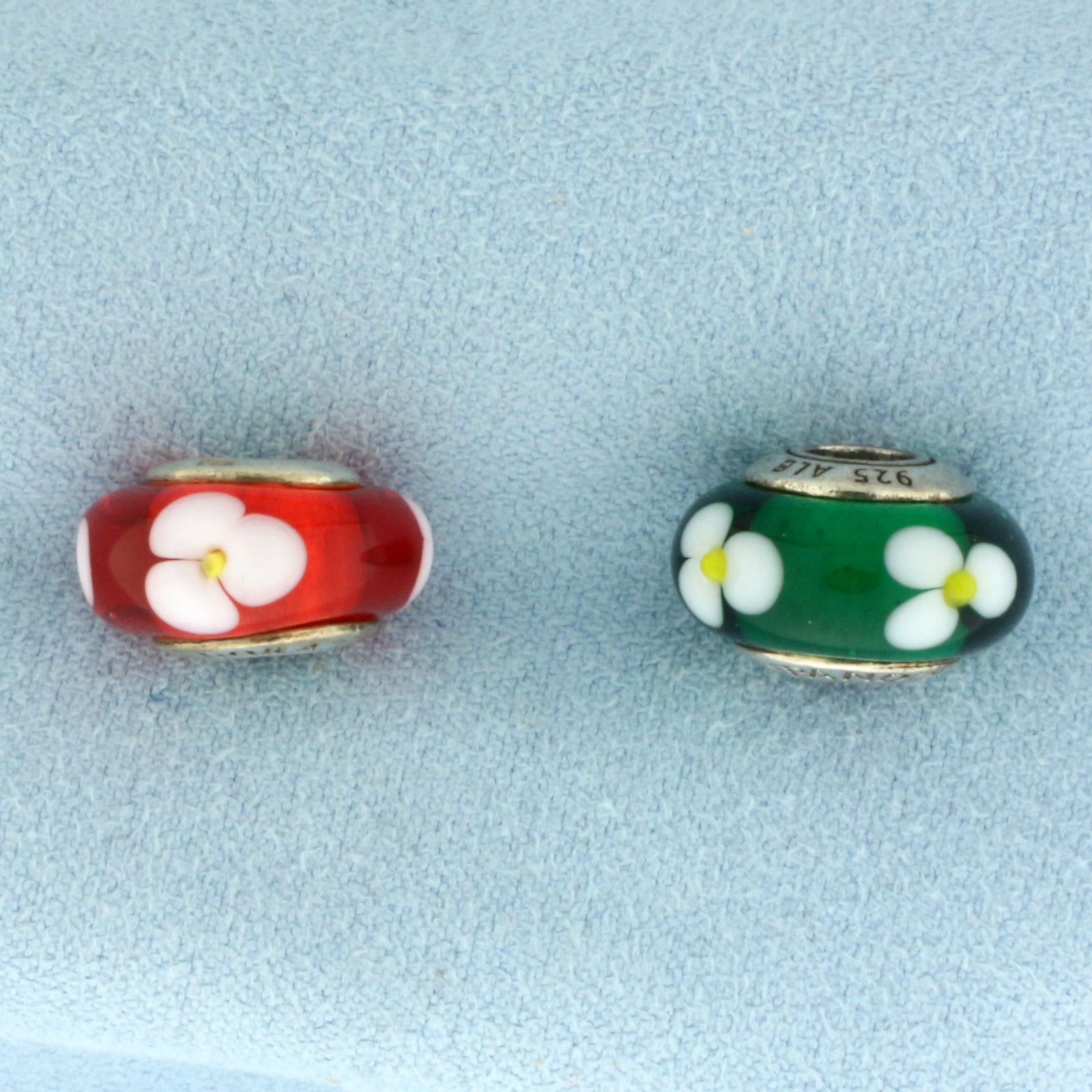 Pandora Retired Murano Glass Flowers for You Beads - Set of 2 in Sterling Silver: In .925 Sterling Silver. Contains one red Murano Italian glass with flower design. Also contains one green Murano Italian glass with flower design. 5/8 inch wide. 6.9g.