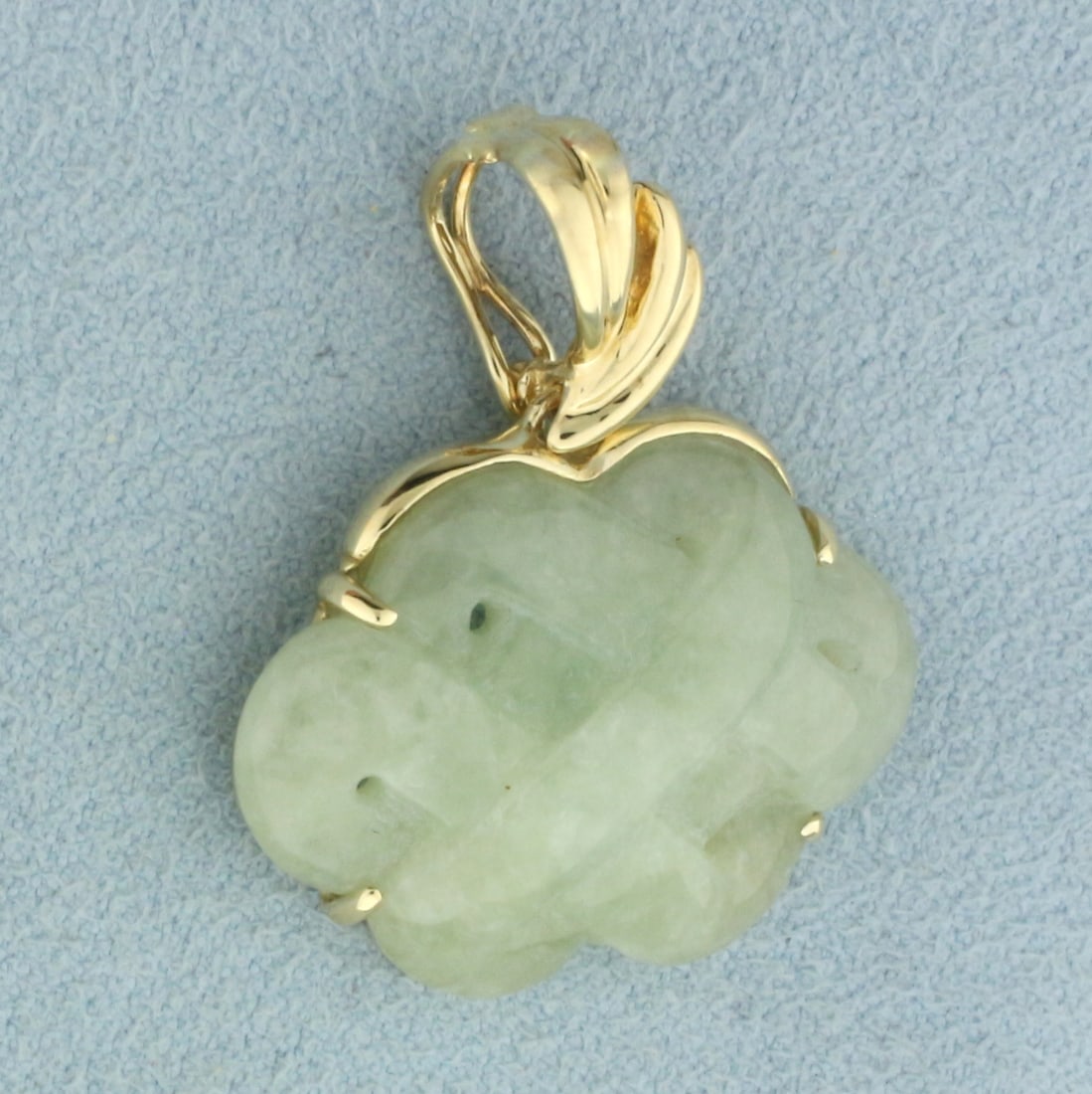 Hand Carved Jade Pendant in 14k Yellow Gold: In 14k yellow gold. Hand Carved Jade with beautiful color. 1 1/8 inches long x 1 inch wide. Bale hinges open to accommodate larger chains. 5.6g.