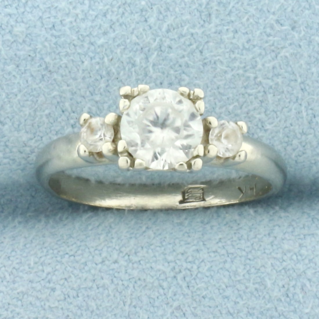 Vintage 3-Stone White Sapphire Ring in 14k White Gold: In 14k White Gold. Contains one 2/3ct an two .05ct high quality white sapphire gemstones with excellent cut and clarity. Minor abrasion on stones, indicative of age. Size 6. 2.2g.