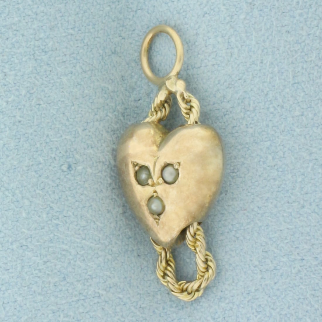 Antique Seed Pearl 3D Heart Charm in 14k Yellow Gold: In 14k Yellow Gold. Contains three high quality seed pearls. 1 1/8 inch long. 3/8 inch wide. Engraved "EMB" in faint lettering. 3.1g.