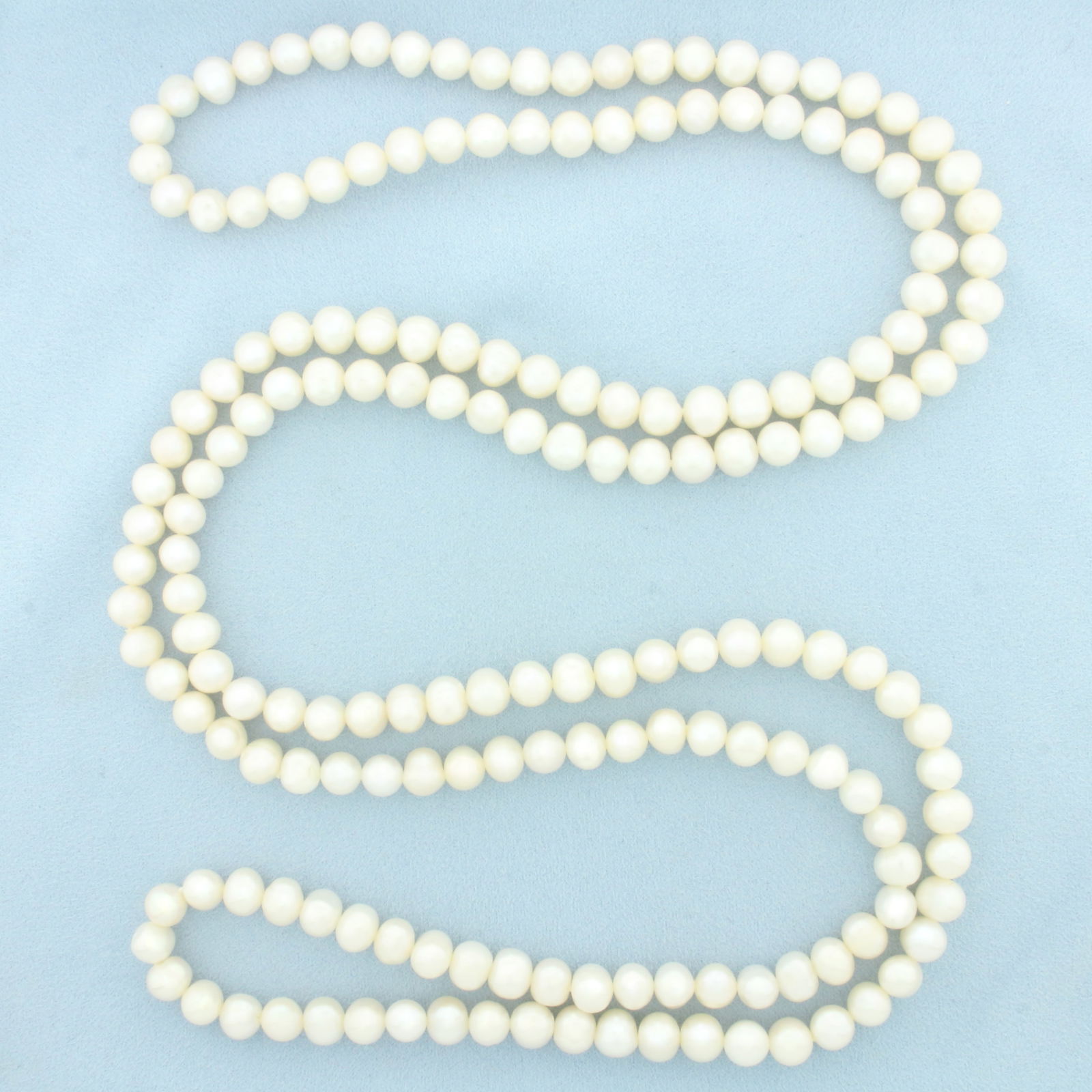 Long Cultured Pearl Strand Necklace: Contains 8.5-9mm high quality Cultured Pearls with high luster. 54 inches long.