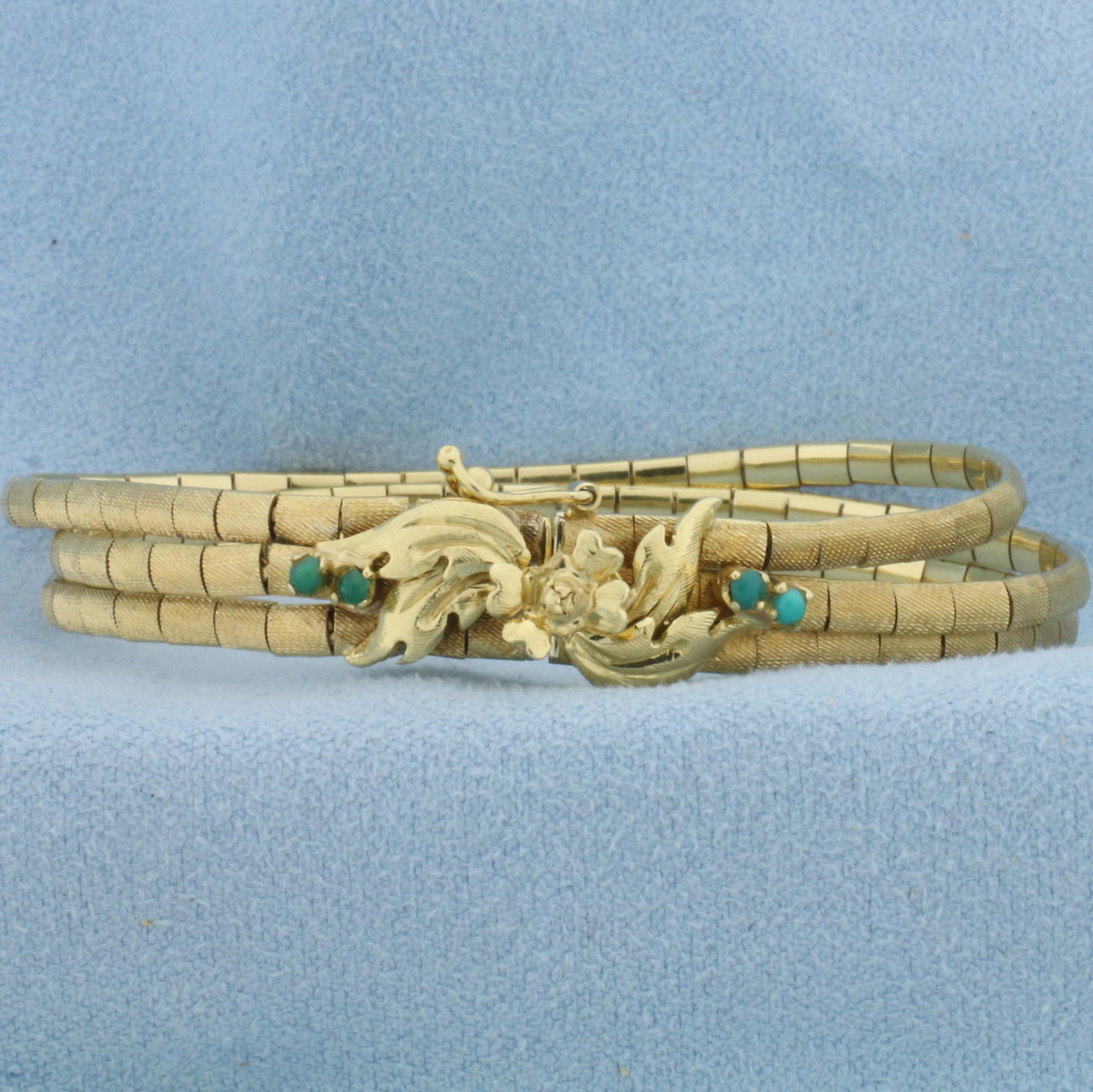 Italian Turquoise Flower Design Bracelet in 18k Yellow Gold: In 18k Yellow Gold. Contains four 2mm high quality turquoise gemstones. 6 1/8 inches long. 8mm wide. Multi-strand design with unique finish. Italian made. Slide clasp with safety latch. 19.0g.